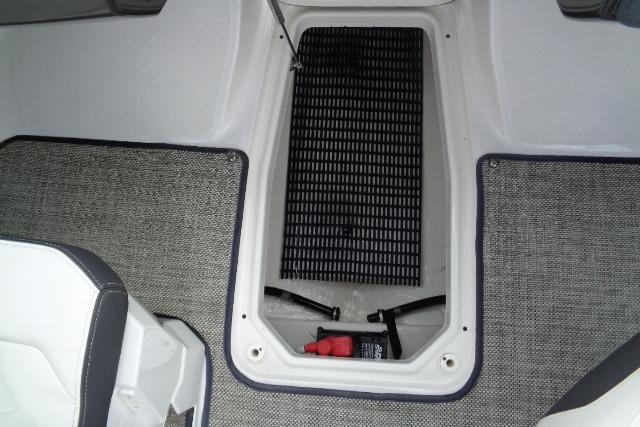 2019 Monterey 218SS Super Sport boat interior storage compartment with carpeted flooring.