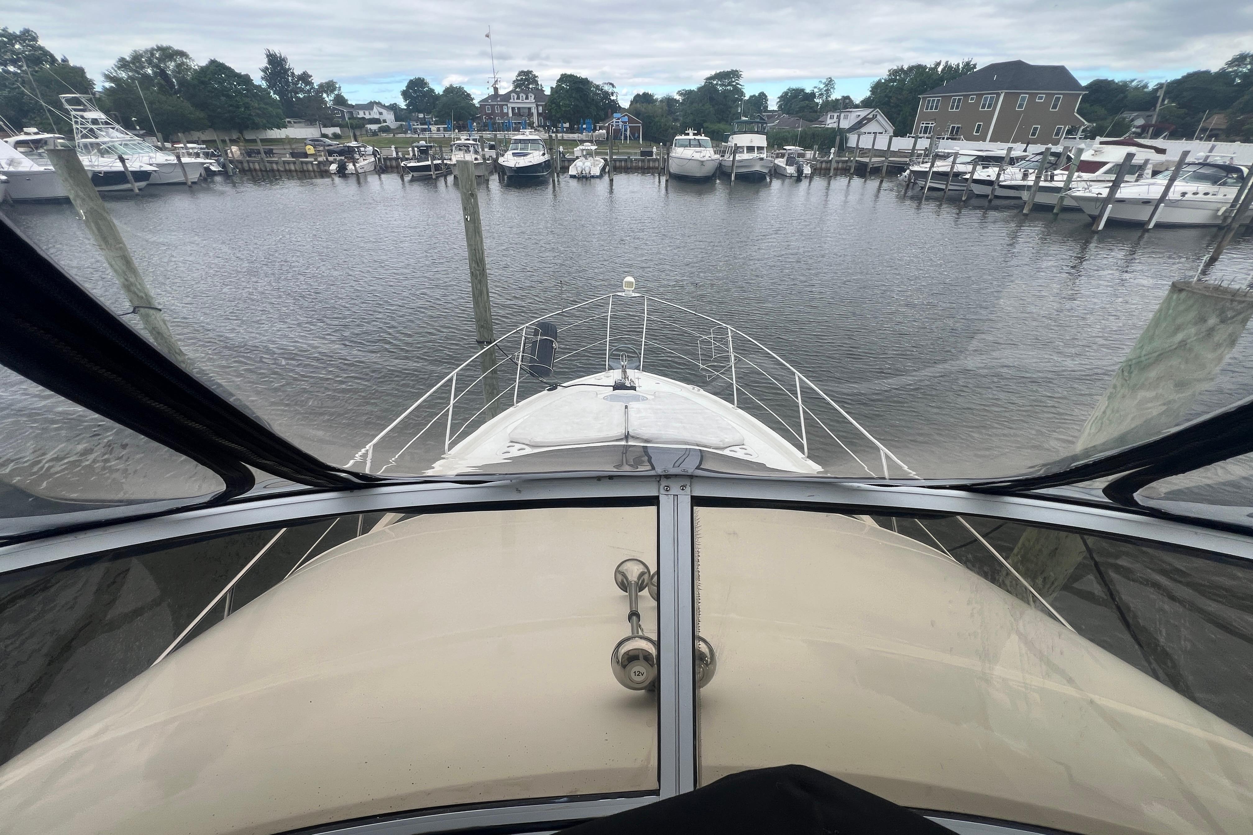 View from the helm of a 2006 Carver 43 Motor Yacht in a marina.