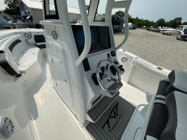 2025 Tidewater 232 CC Adventure boat interior with steering console and seating.