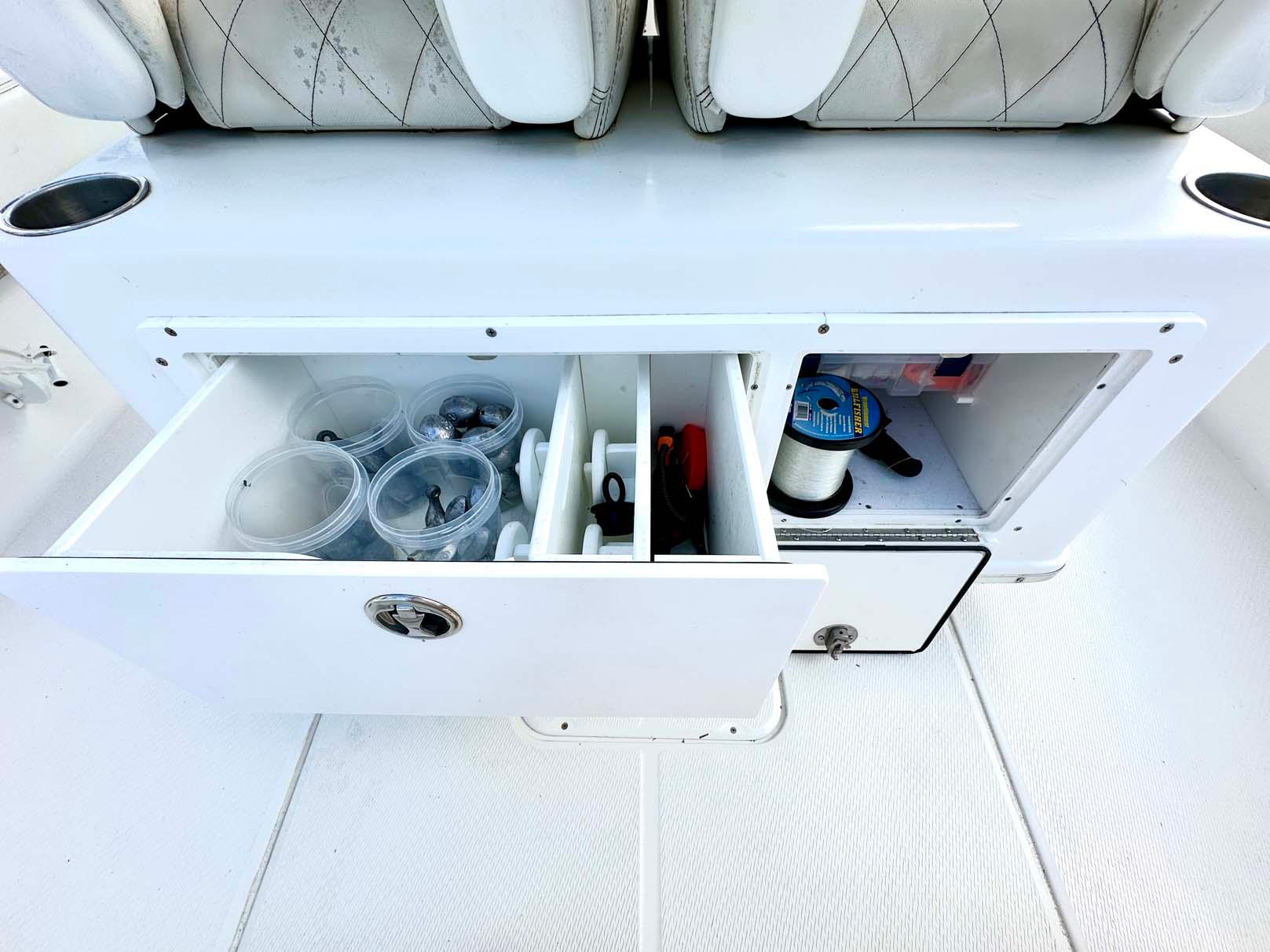 2020 Blue Wave 2800 Pure Hybrid boat storage compartment with fishing gear and accessories.