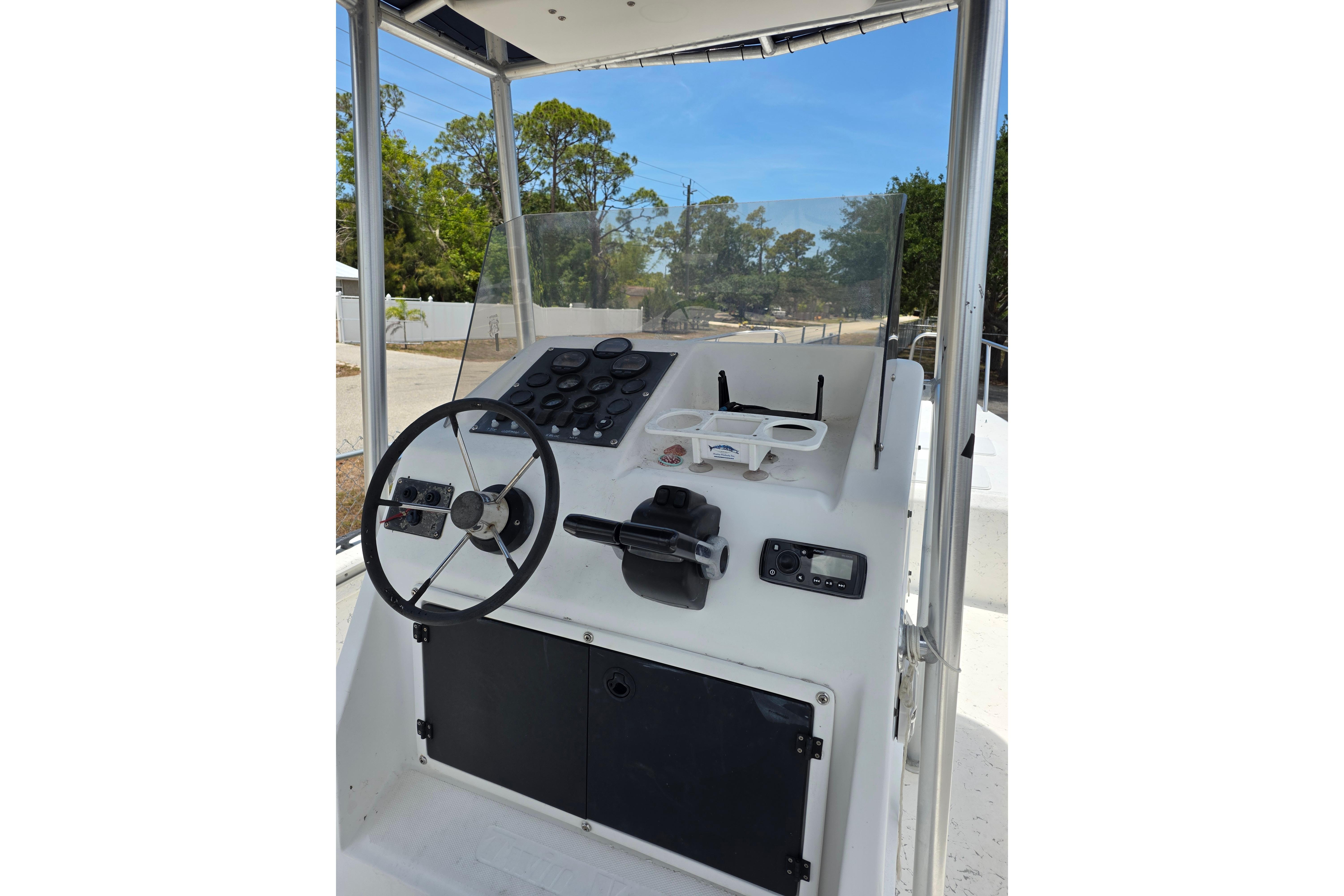 1999 Twin Vee Awesome 22 boat console with steering wheel and control panel.
