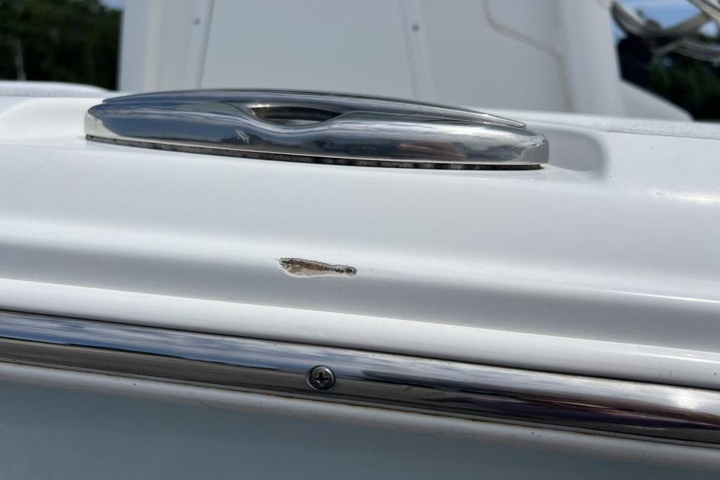 Close-up of a 2021 Sea Hunt Gamefish 25 boat with a small surface scratch.