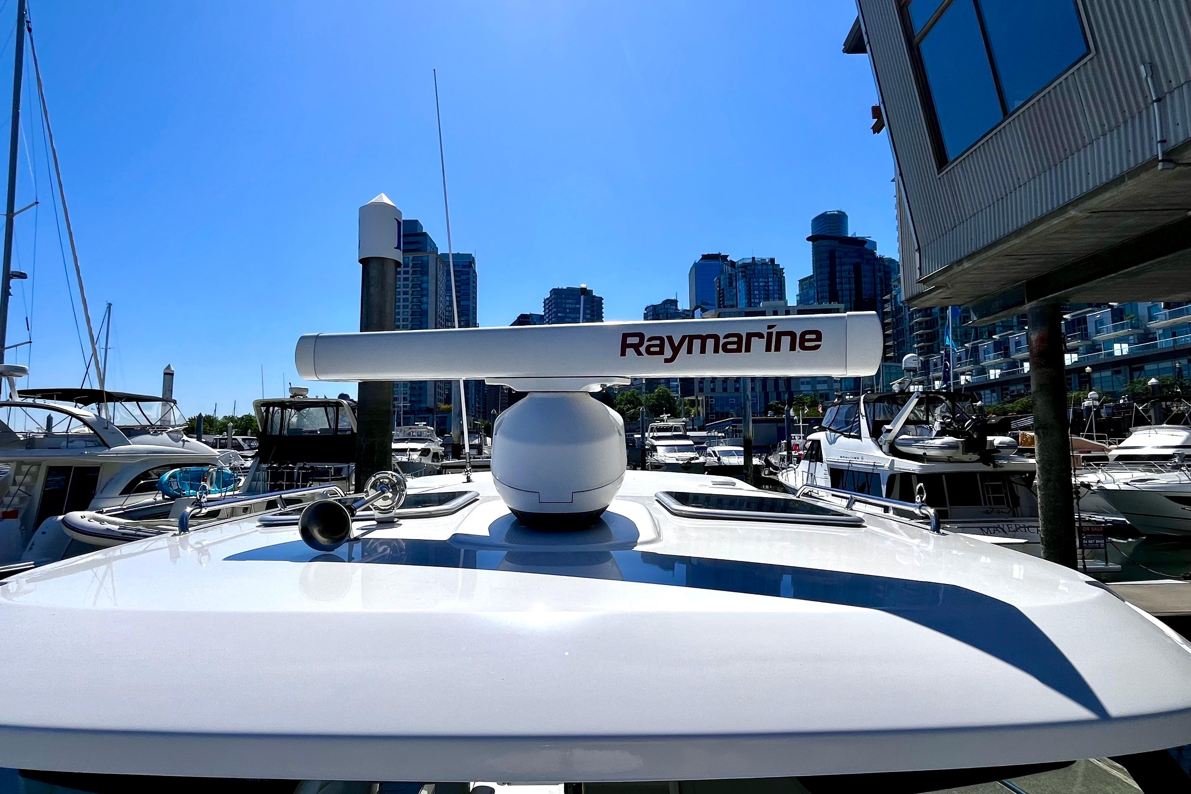 Boston Whaler 325 Conquest Pilothouse 2026 with Raymarine radar at marina.