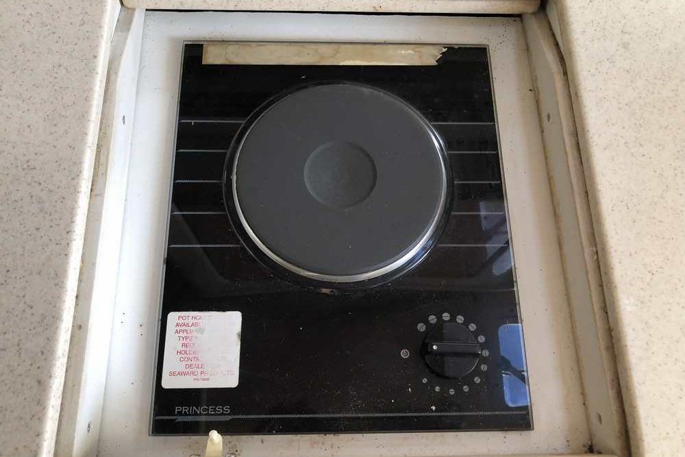 Built-in stovetop on 1999 Regal Commodore 2760 boat, featuring a single burner and control knob.