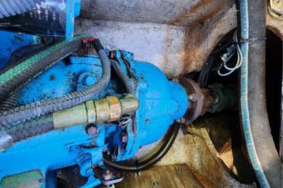 Engine compartment of a 1985 Wasque Down East Cruiser with visible mechanical components.