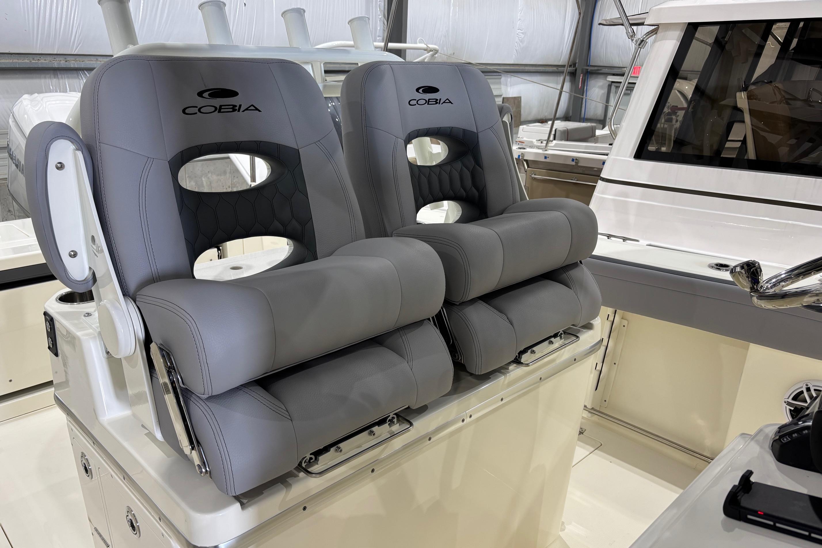 2026 Cobia 285 Open Center Console boat with luxurious gray seating.
