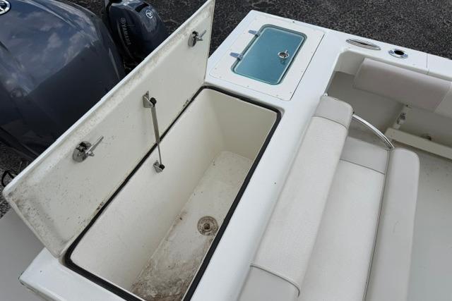2016 Parker 2520 Sport Cabin boat with open storage compartment and seating area.