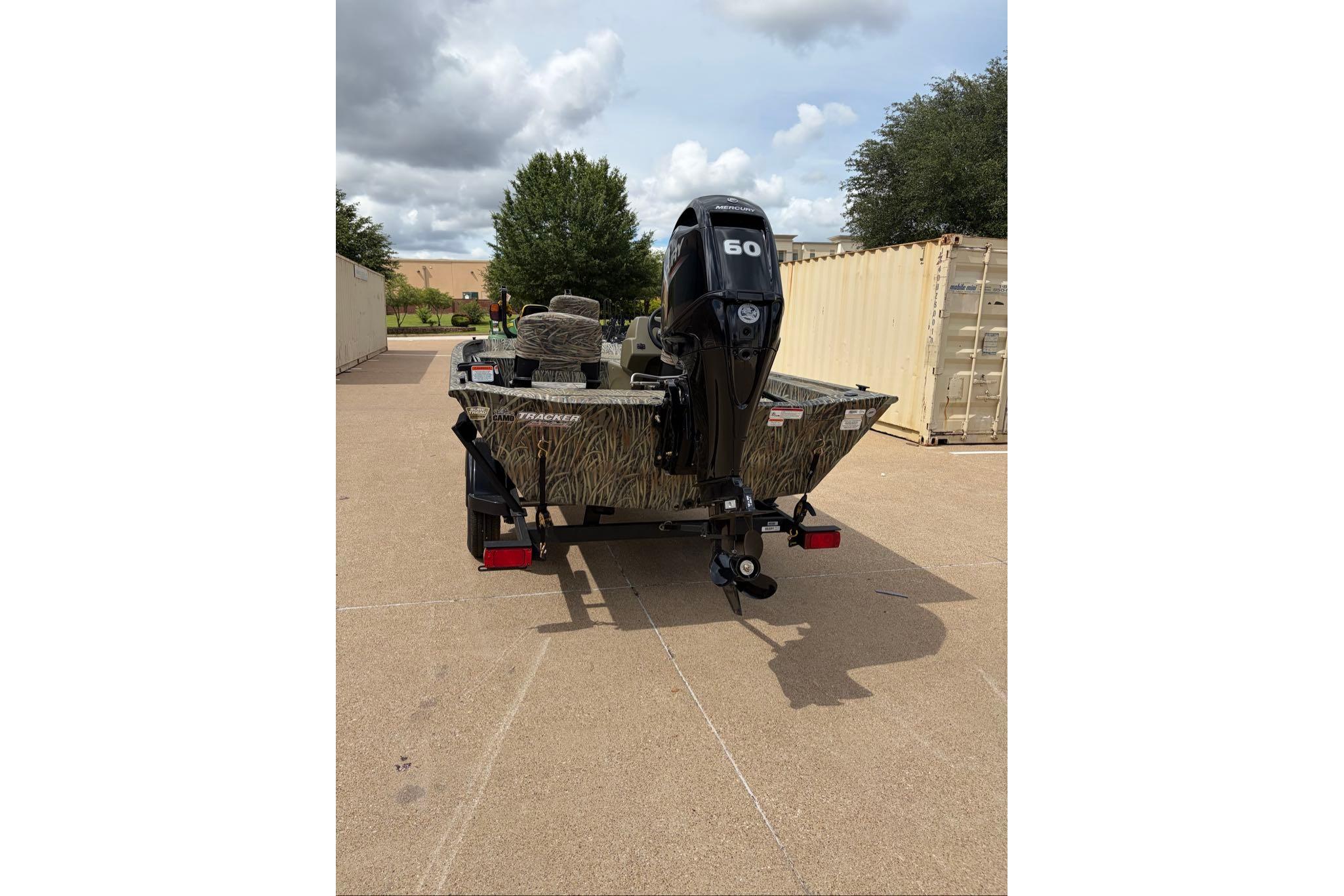 2026 Tracker Grizzly 1754 SC boat with 60 HP motor, parked outdoors.