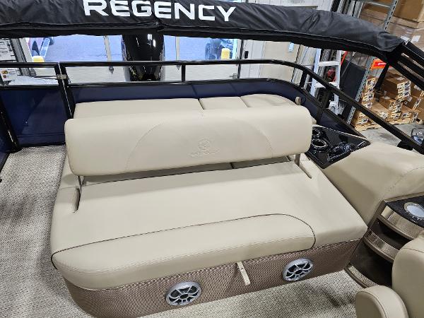 2024 Regency 250 DL3 boat interior with beige seating and black railing.