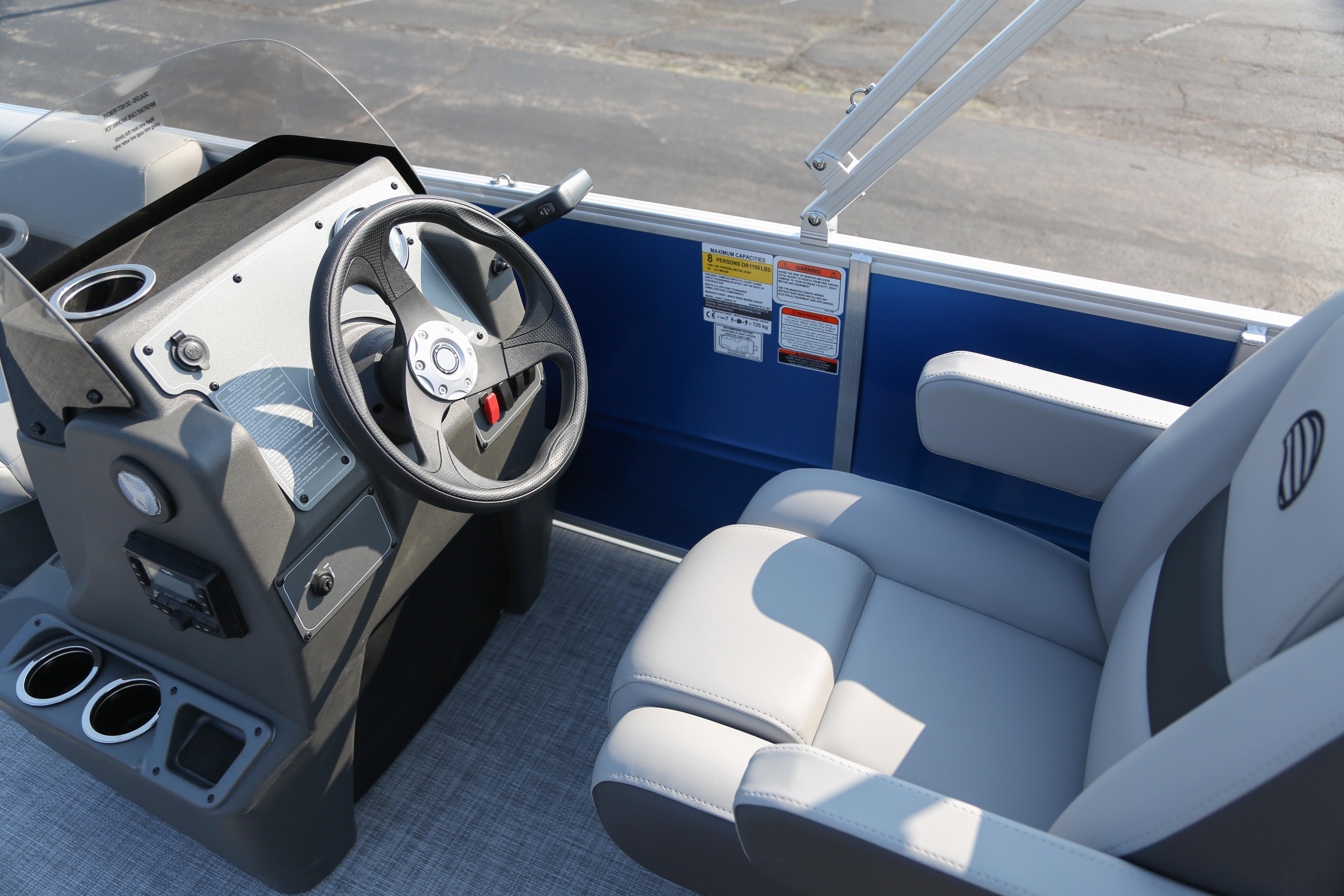 2026 Sun Tracker Party Barge 16 DLX helm with steering wheel and comfortable seating.