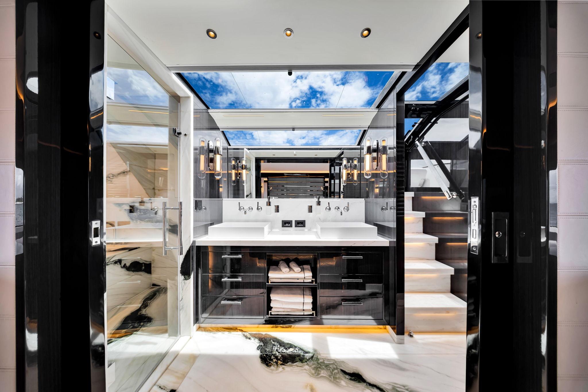 Luxurious bathroom interior on 2021 Sirena 88 yacht, featuring modern design and skylight.