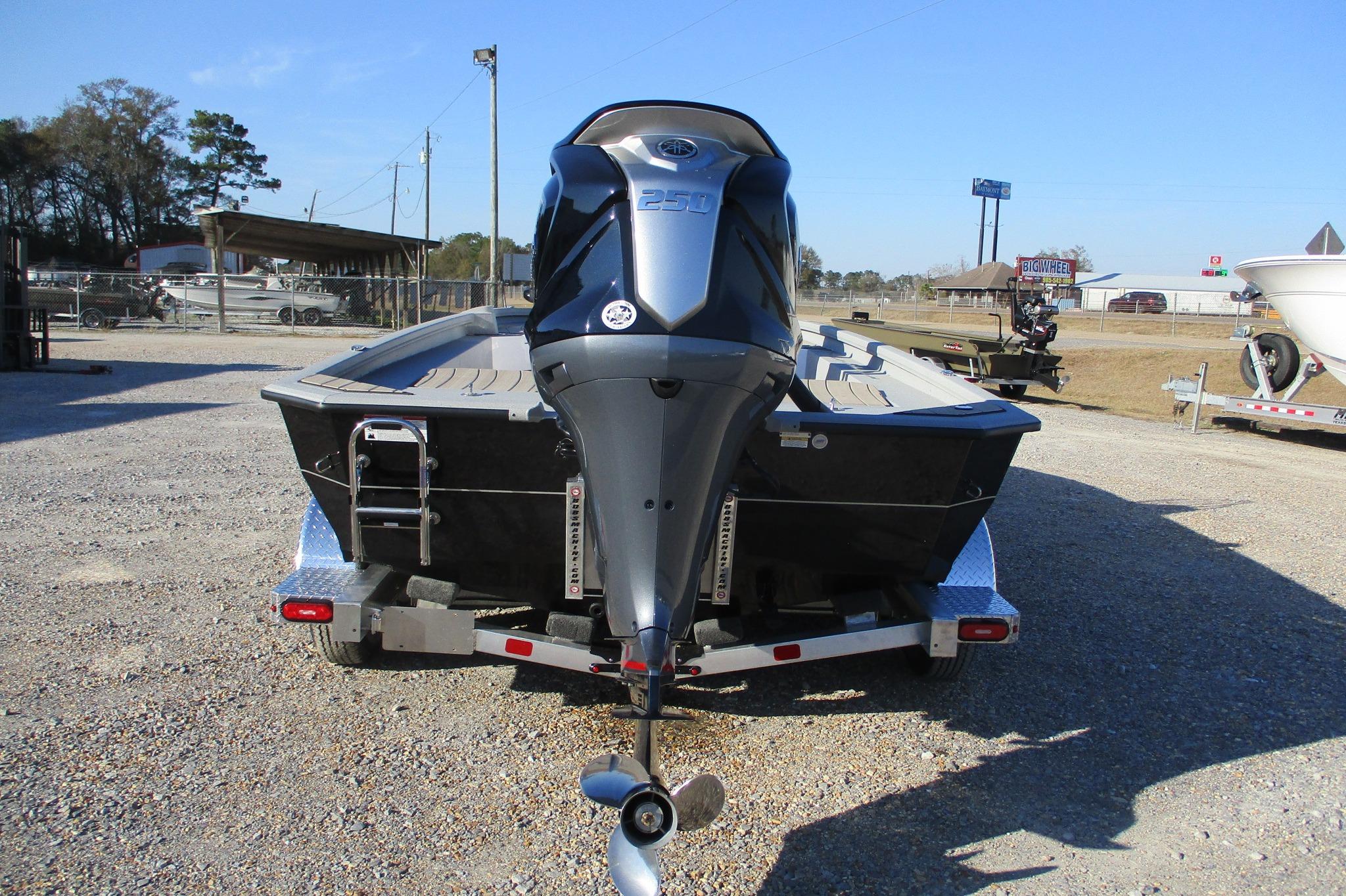 2026 Vexus ACX2210 boat on trailer, rear view with powerful outboard motor.