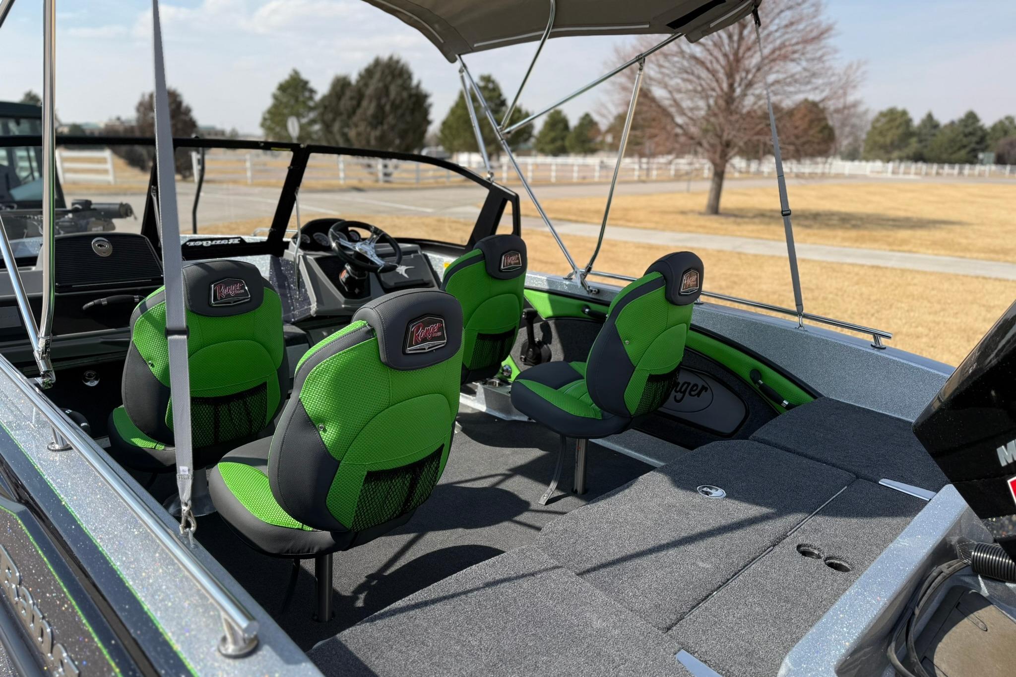 2026 Ranger 1880MS boat interior with green seats and canopy in a park setting.