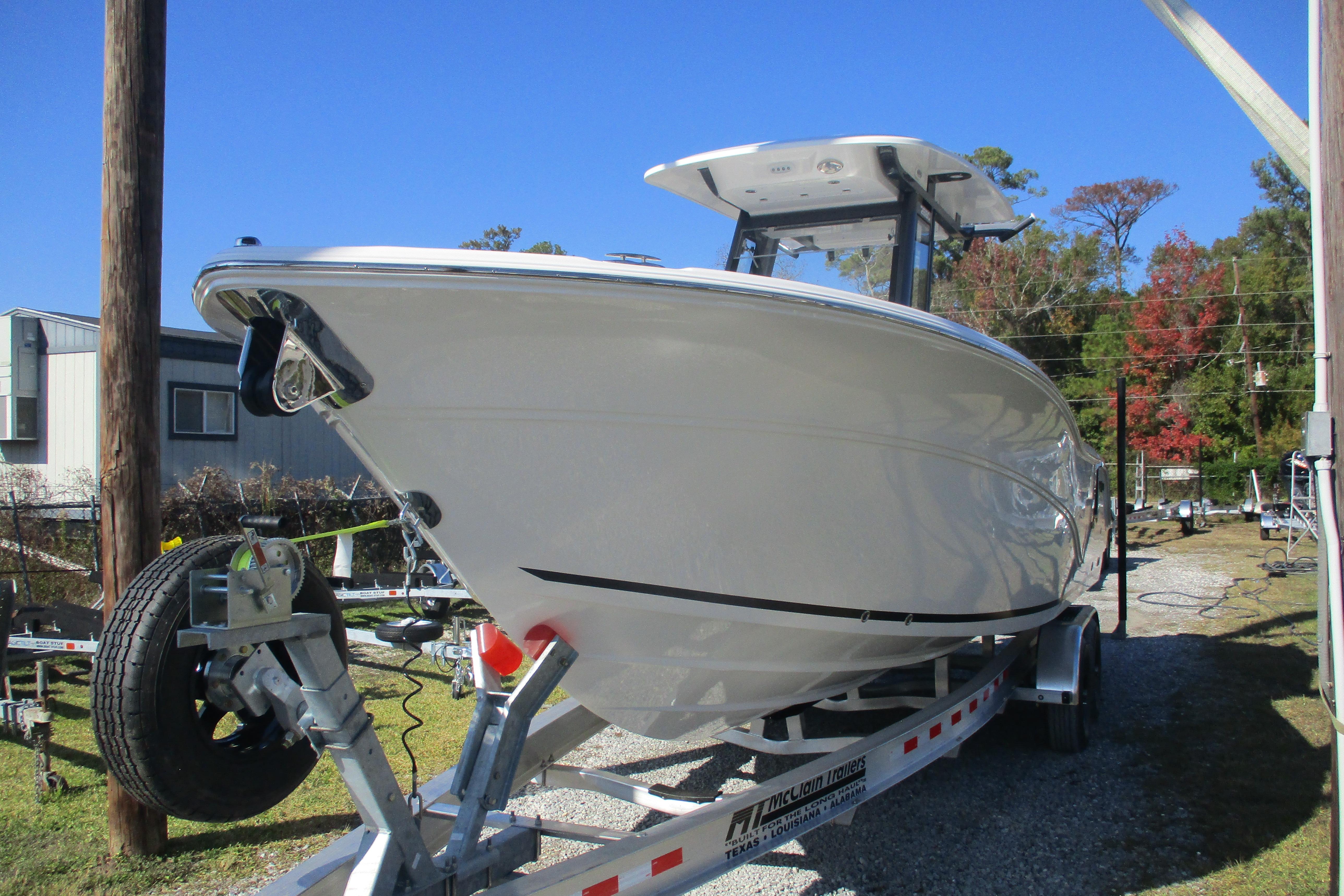 2026 Sea Fox 268 Commander boat on trailer, parked outdoors under clear blue sky.