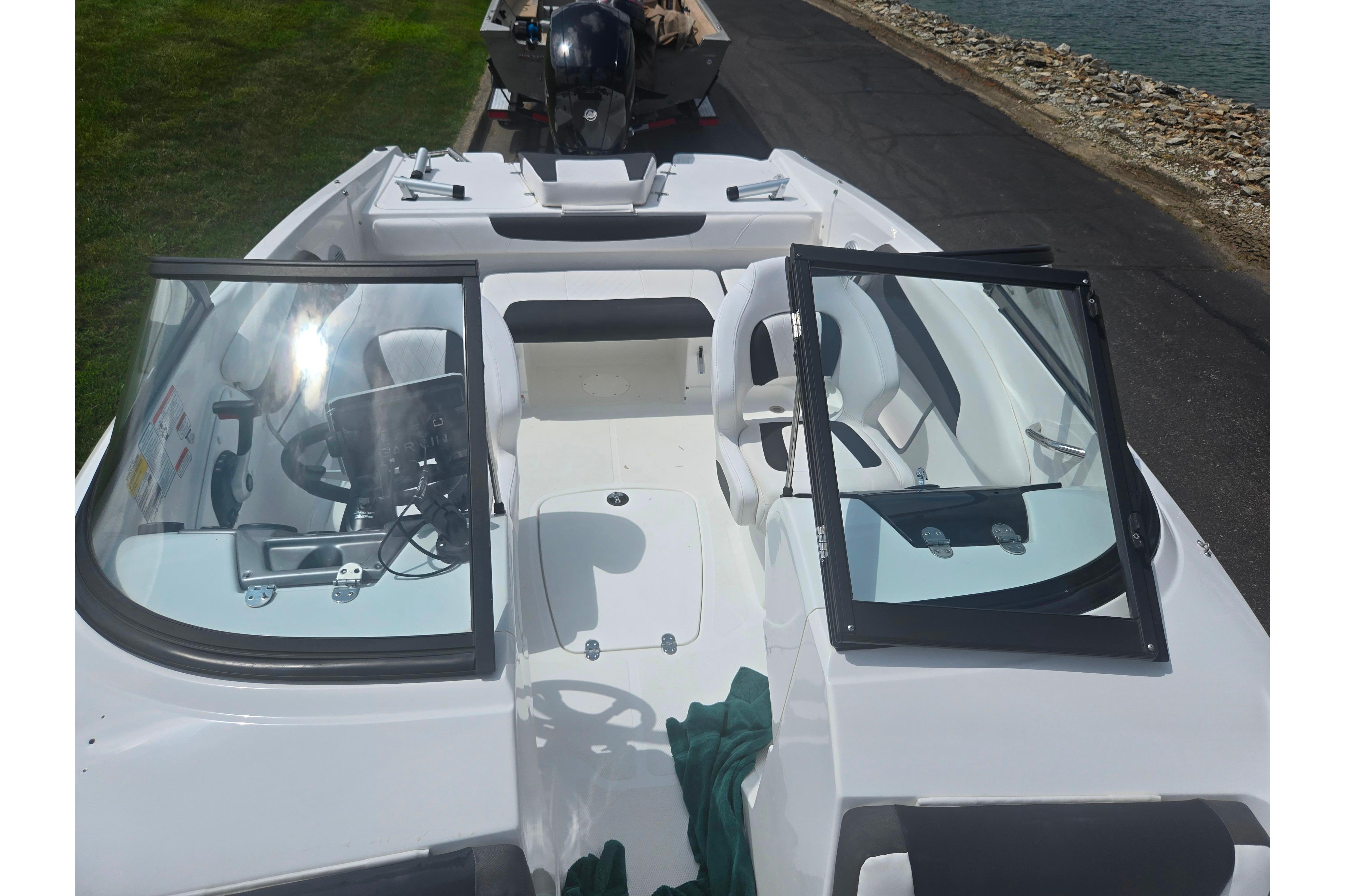 2023 Tahoe 200 S boat interior with open windshield, steering wheel, and seating.