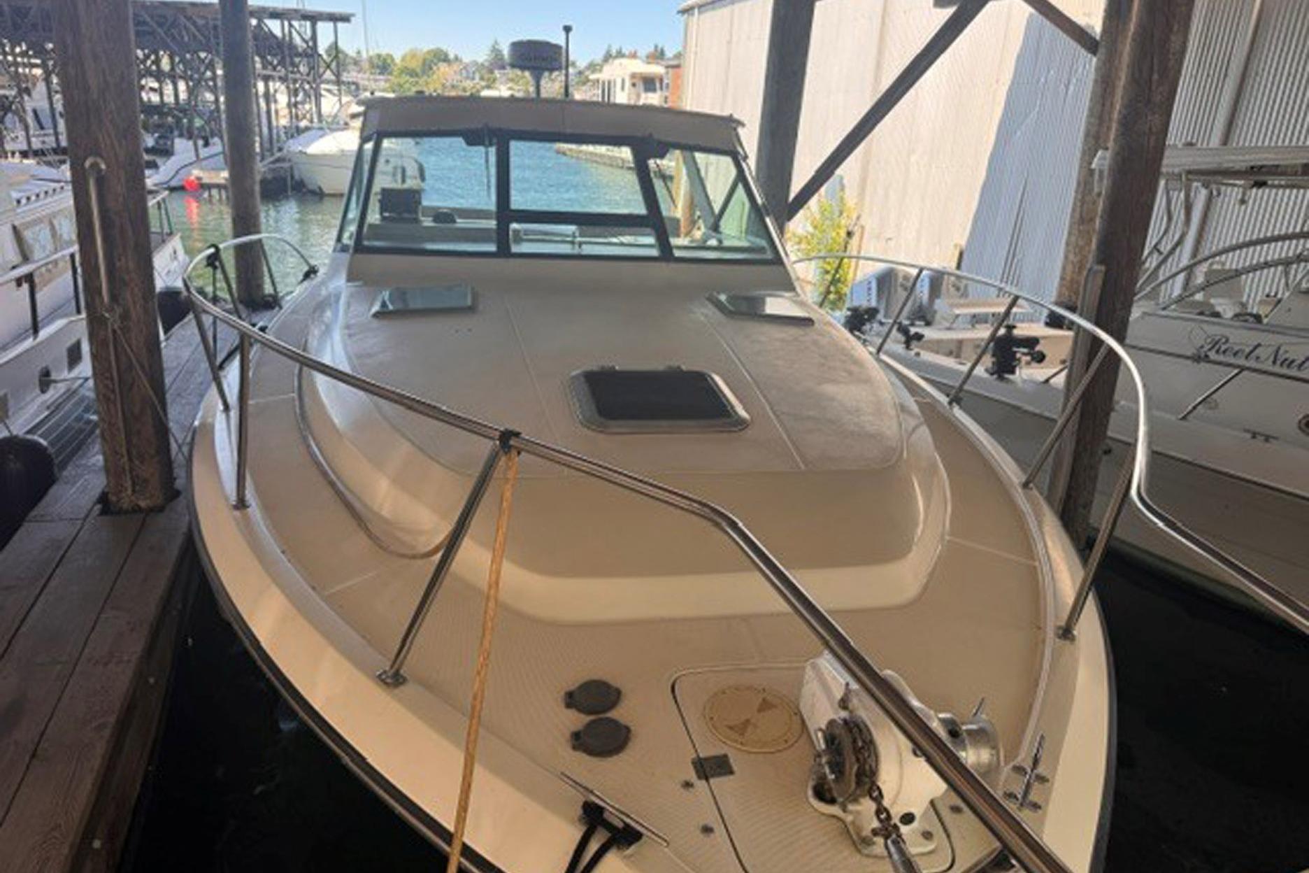 1988 Tiara Yachts 3300 Open docked in a marina, showcasing its sleek design.
