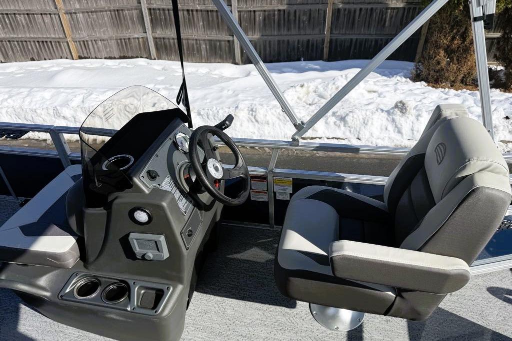 2026 Sun Tracker Bass Buggy 16 XL Select boat interior with steering console and captain's chair.