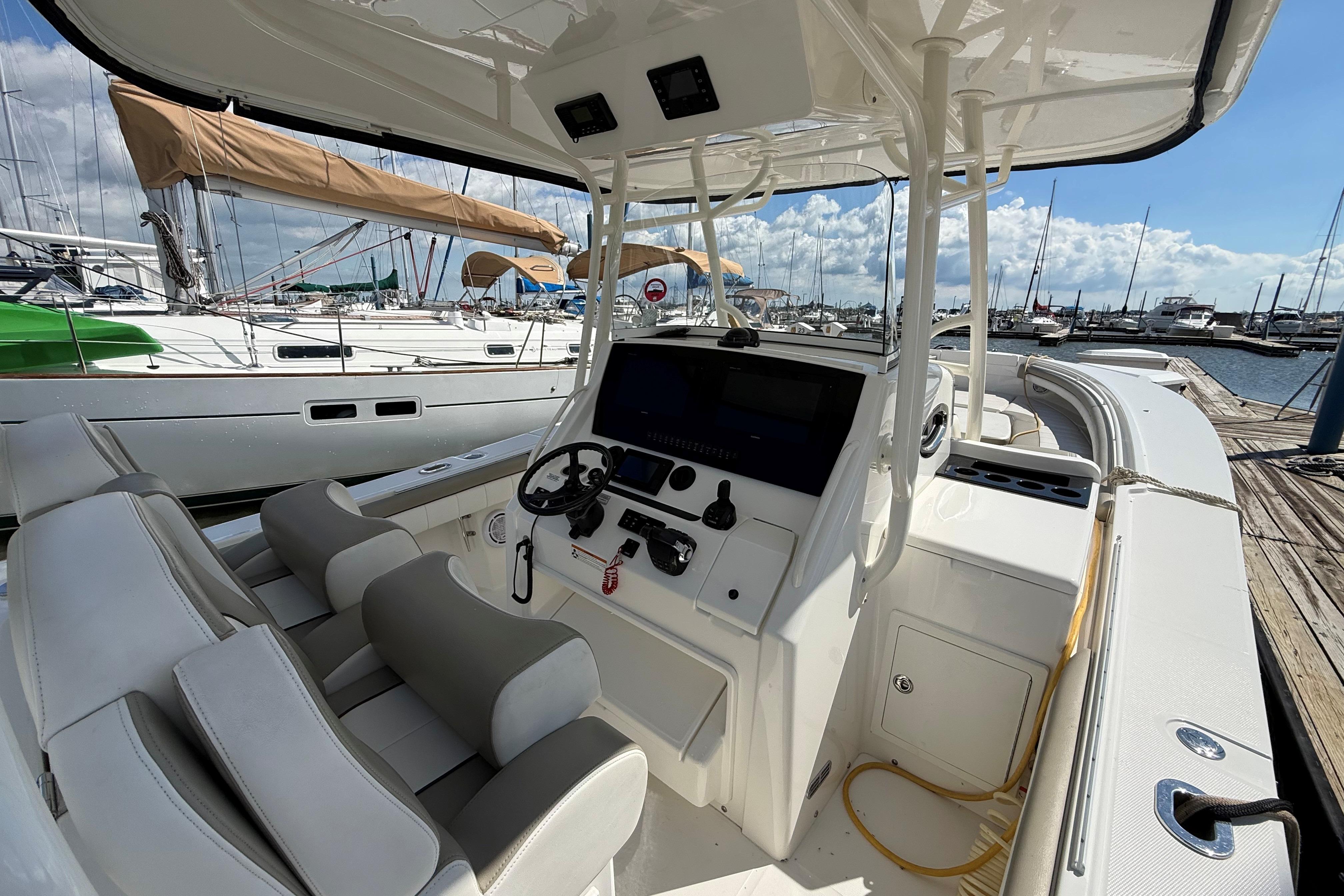 2019 Regulator 34SS boat interior at marina, featuring helm and seating.