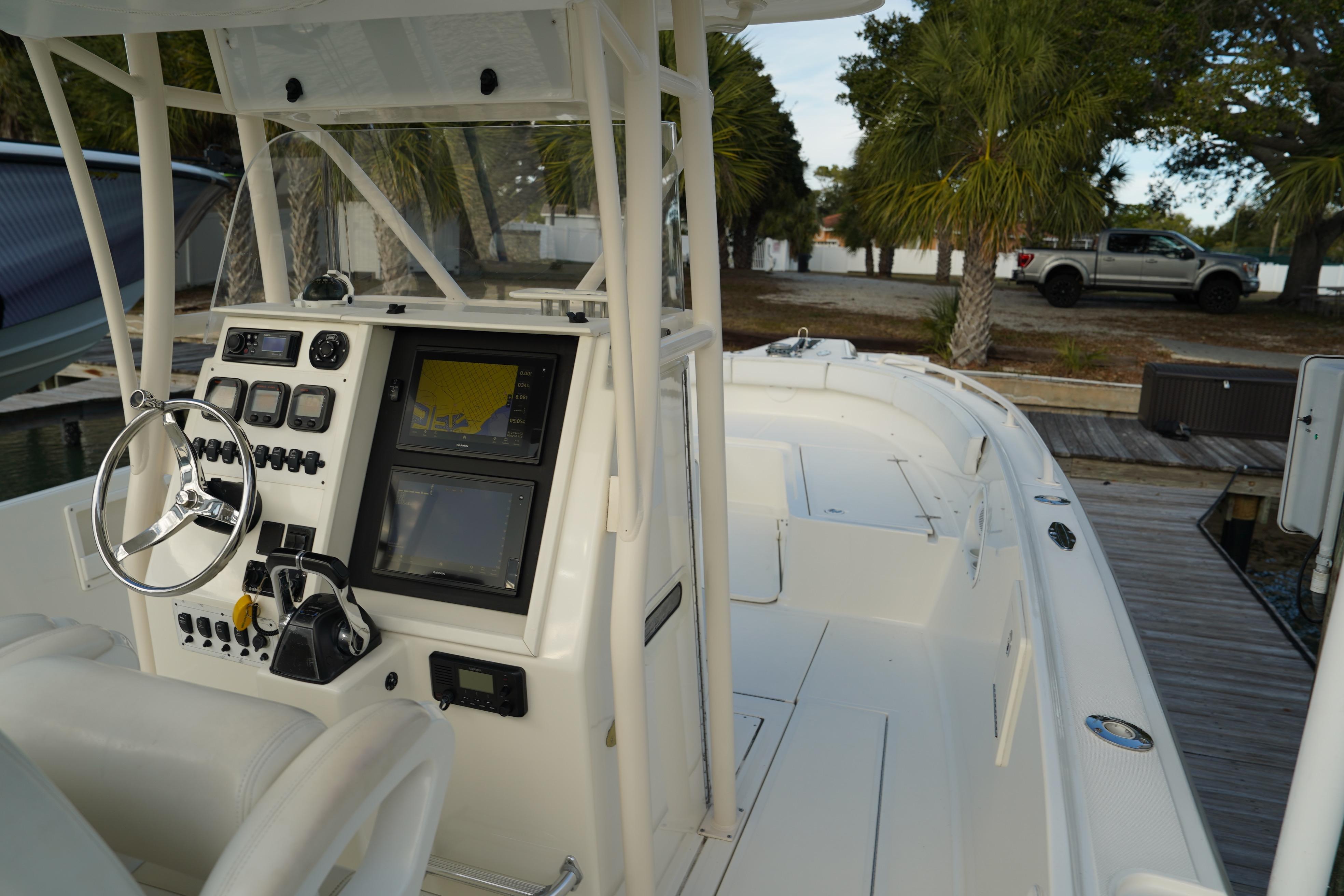 2013 Stamas 317 Tarpon boat cockpit with steering wheel and navigation controls.