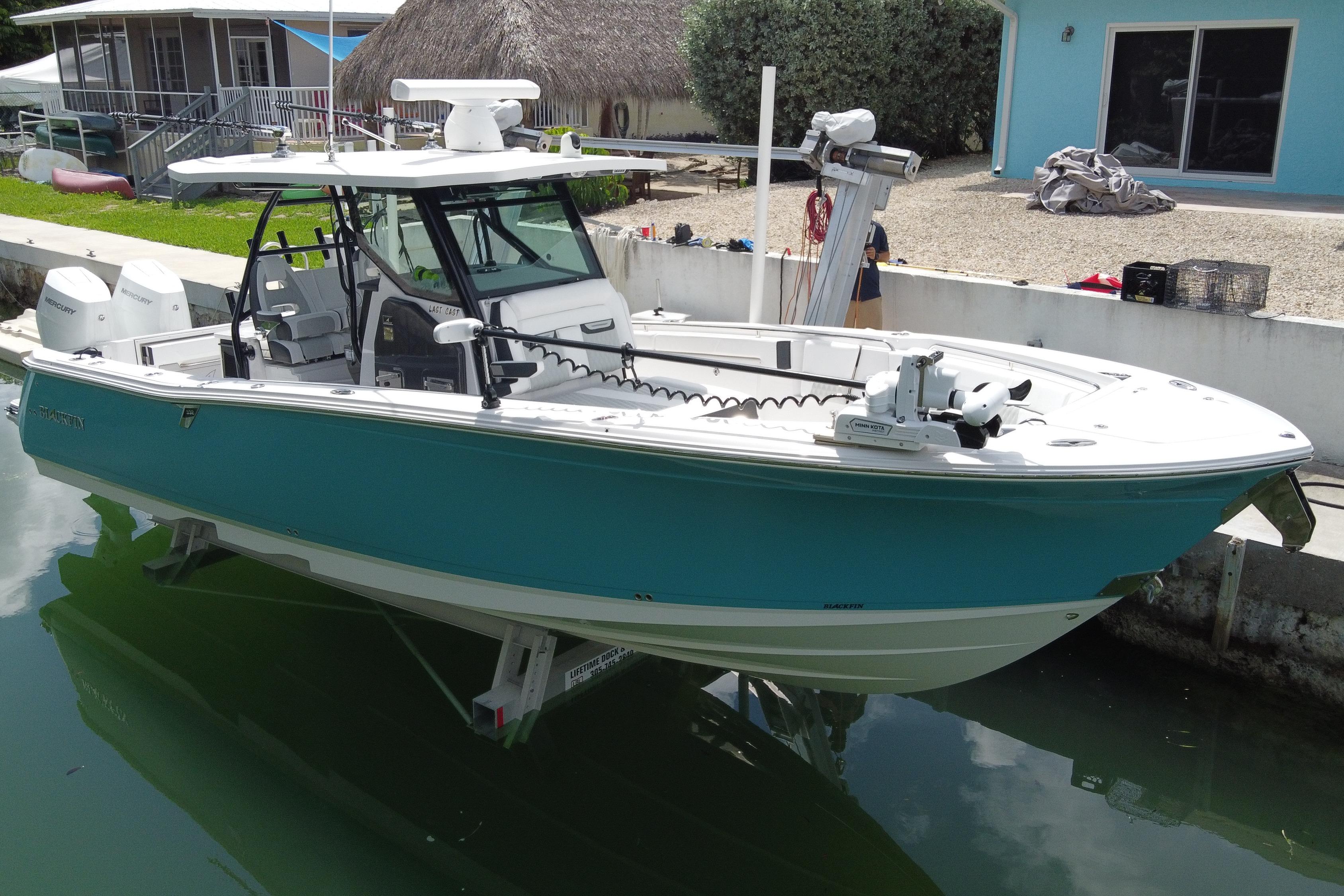 2024 Blackfin 332 CC boat docked, featuring a sleek design and modern equipment.