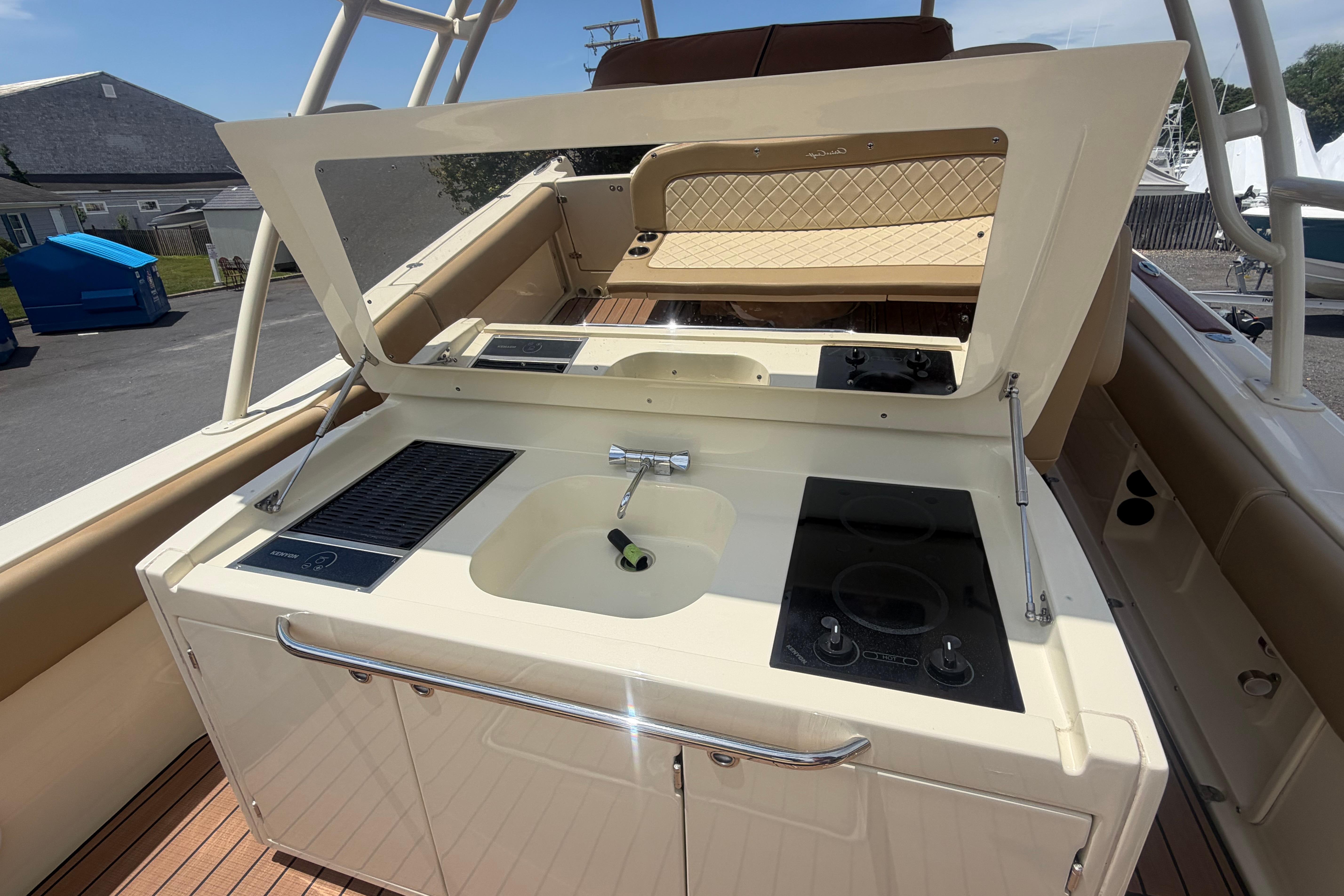 Outdoor kitchen on 2017 Chris-Craft Catalina 34 boat with sink and stove.