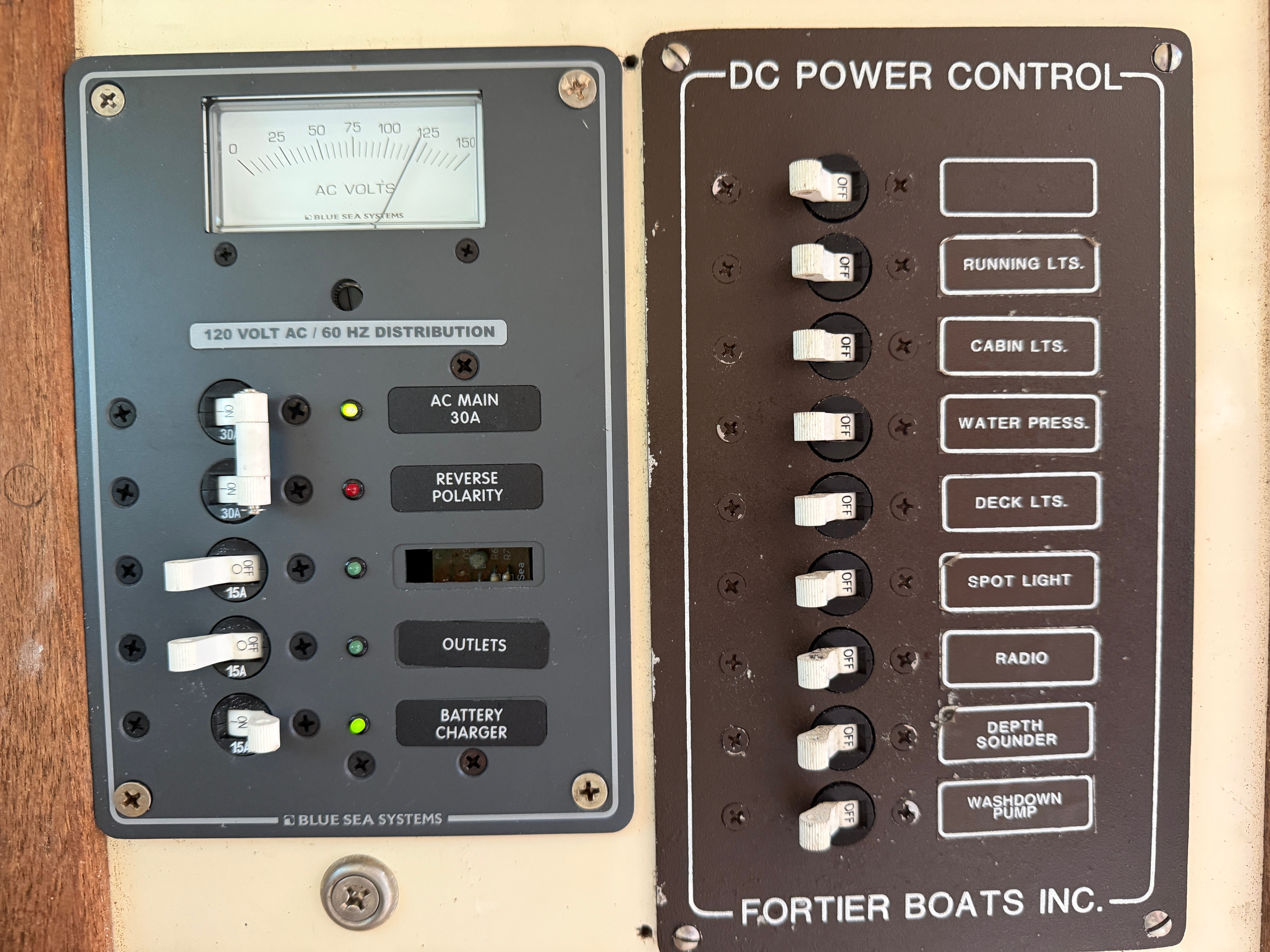 Control panel of a Fortier boat with various switches and gauges.