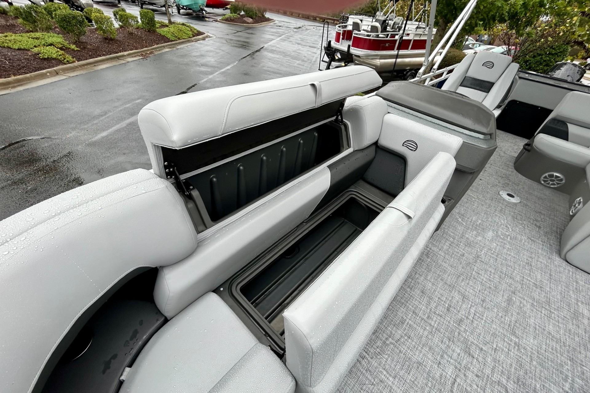 2026 Sun Tracker SportFish 22 DLX boat interior with open storage compartments.