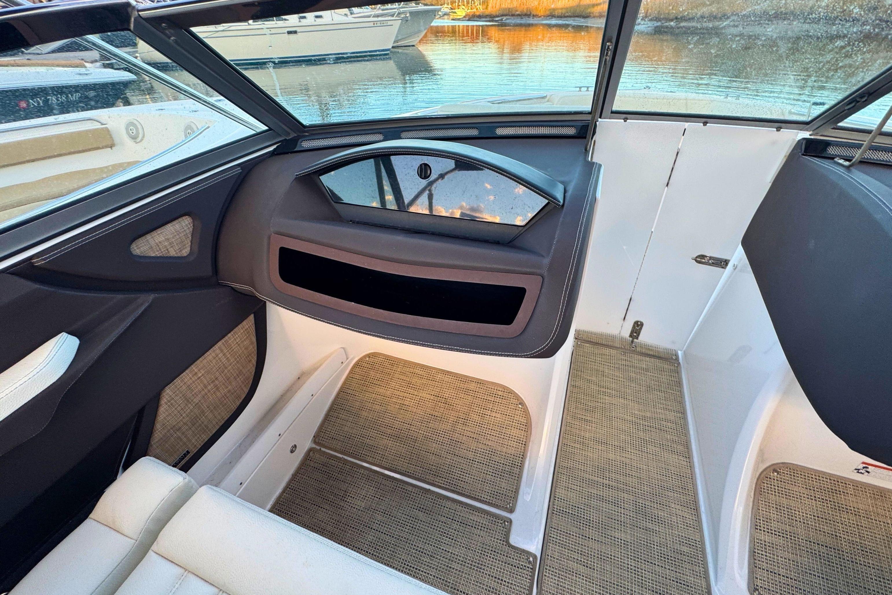 Interior of a 2019 Cobalt R3 boat, featuring seating and window view.