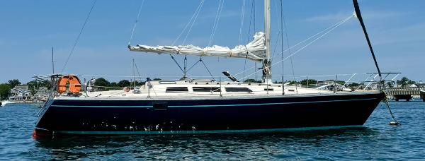 1983 O'Day 39 sailboat on calm water, featuring sleek design and white sails.