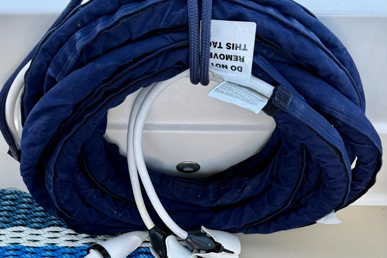 Coiled blue marine hose on 2015 Sabre 38 Salon Express boat deck.