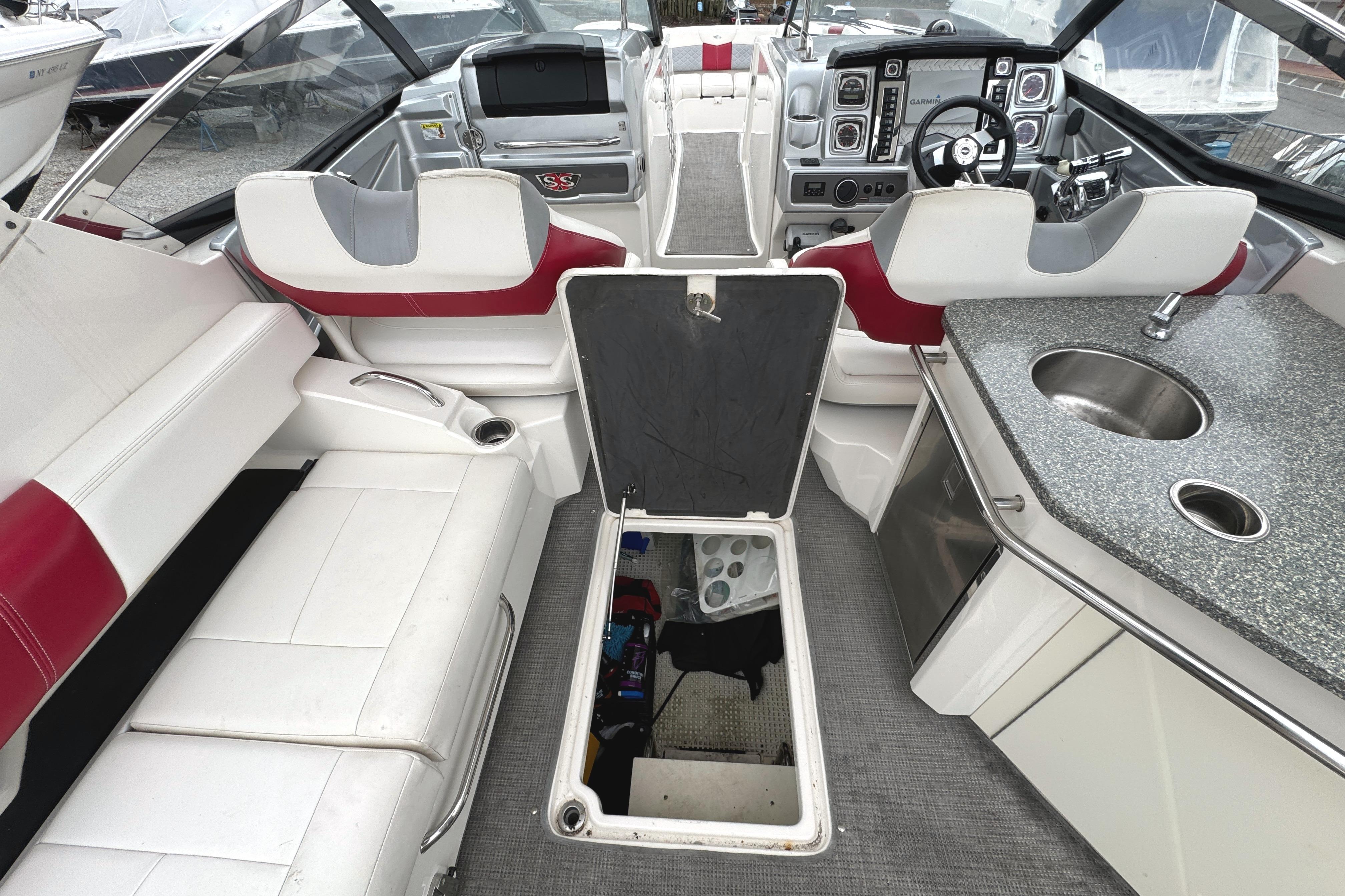 Interior of 2012 Chaparral 327 SSX boat with seating, helm, and kitchenette.