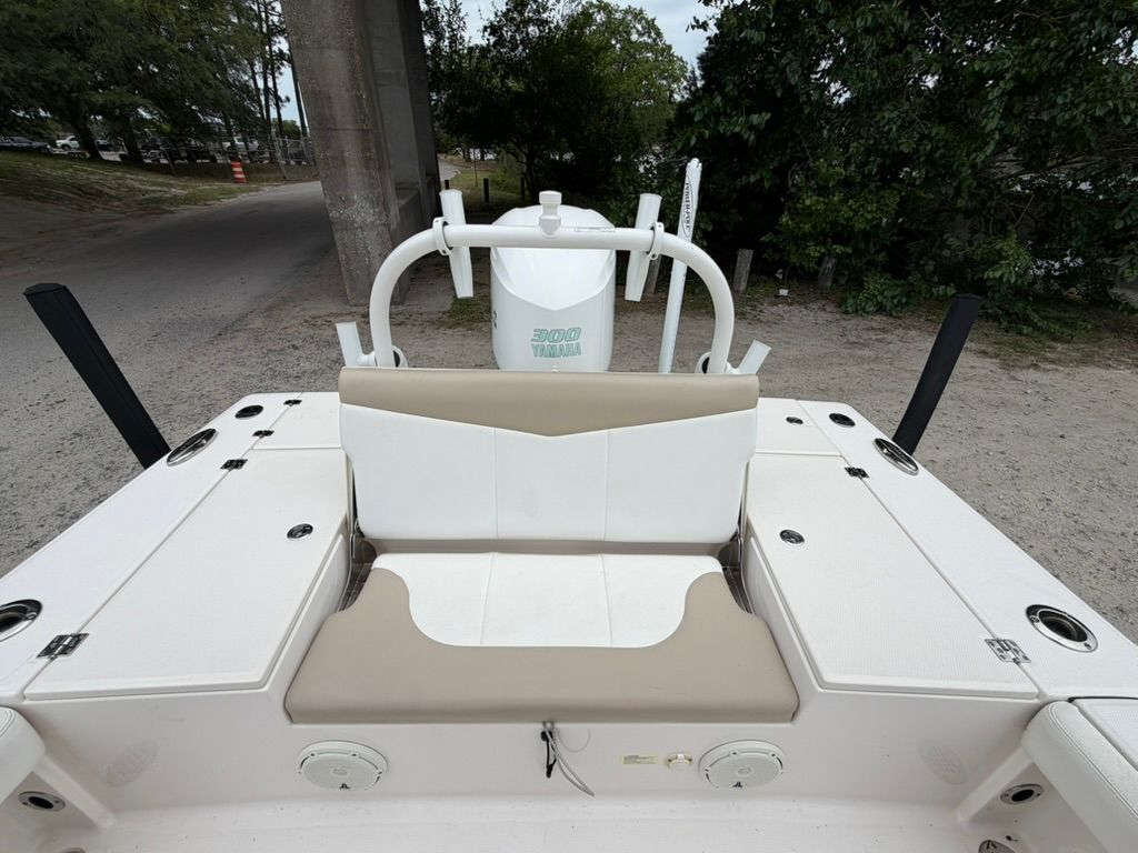 2018 Robalo 246 Cayman SD boat with beige and white seating, parked.