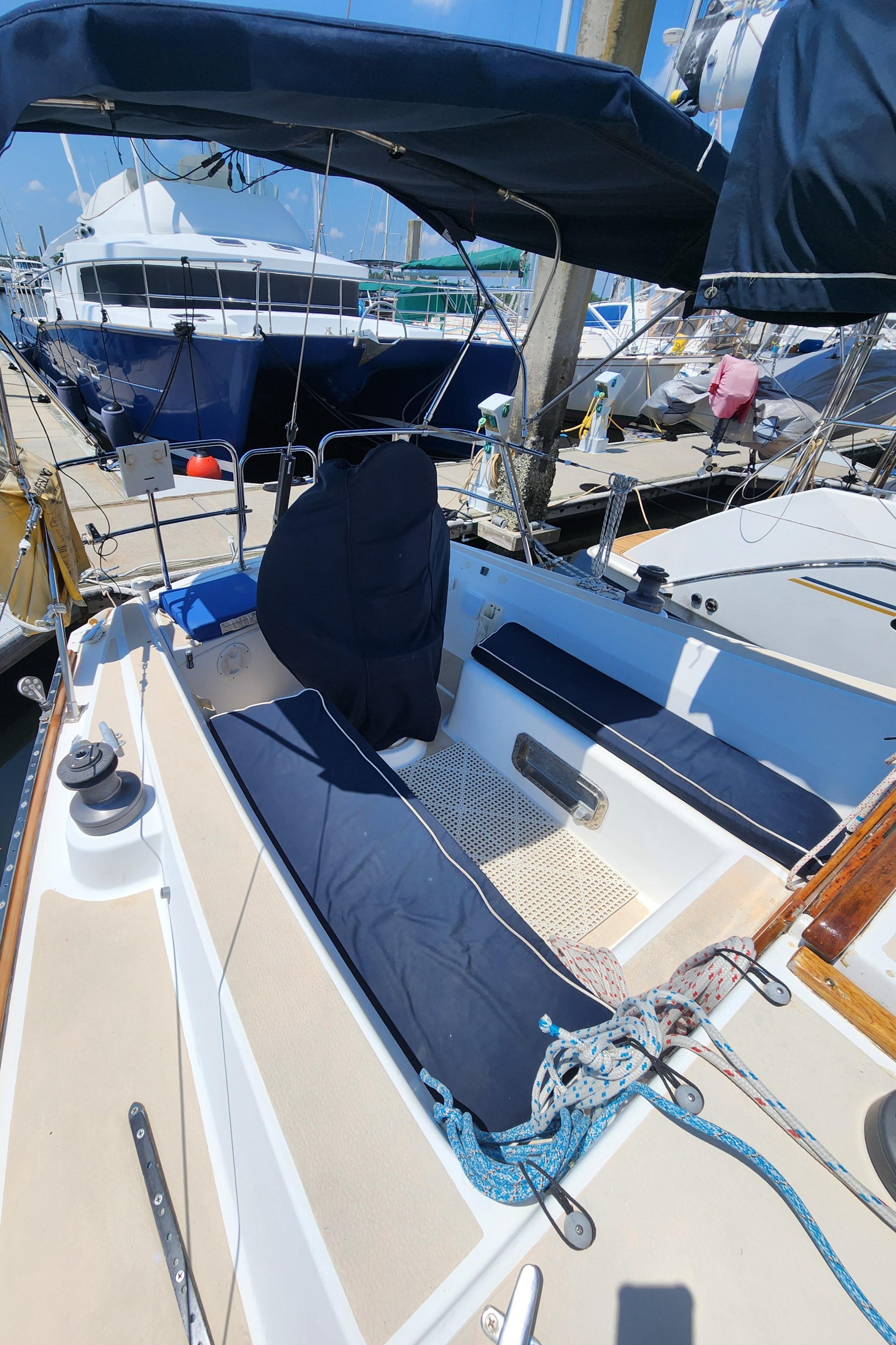 1986 Tartan 34-2 sailboat cockpit with blue cushions and canopy at marina.