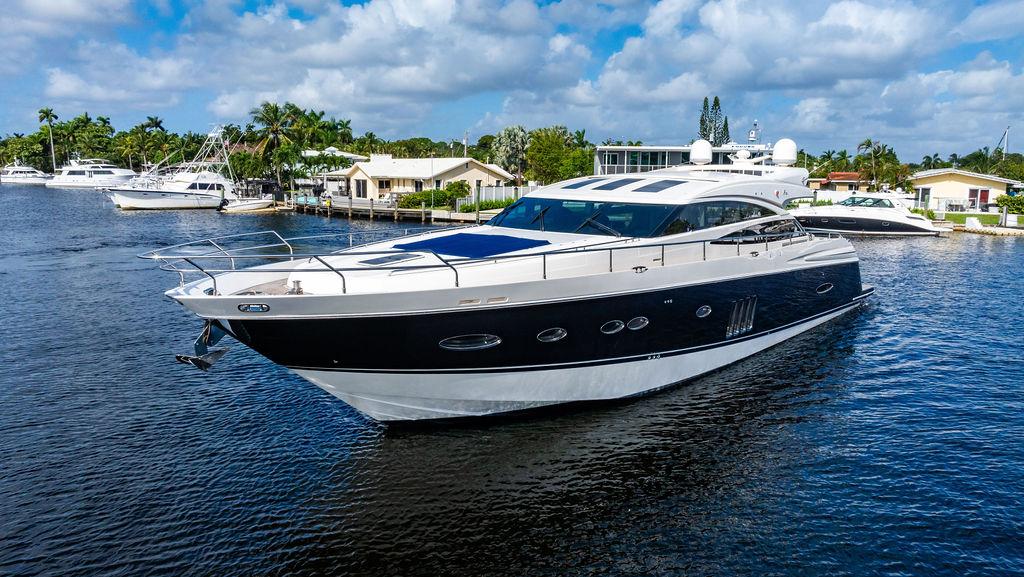 Luxurious 2010 Princess V78 yacht cruising on a serene waterway.