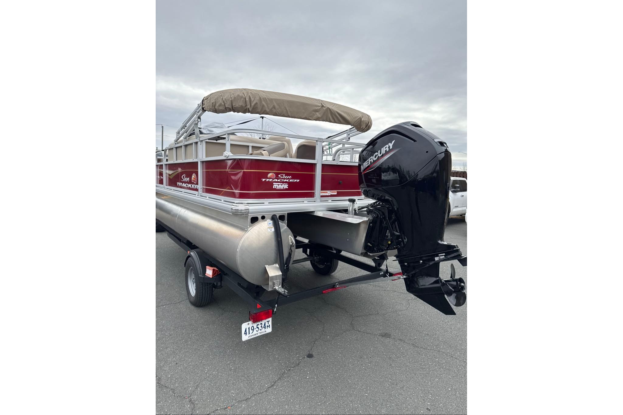 2024 Sun Tracker Bass Buggy 18 DLX pontoon boat with Mercury outboard motor on trailer.