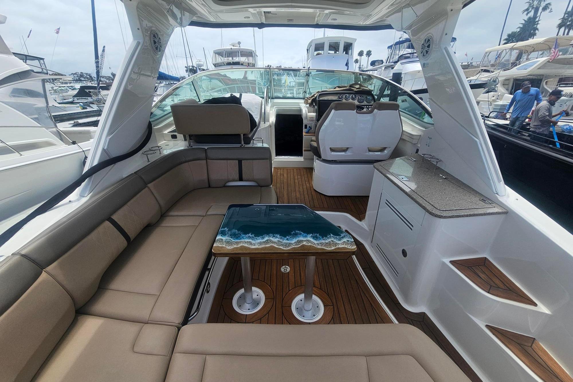 Interior of 2016 Sea Ray Sundancer 350 yacht with elegant seating and ocean-themed table.