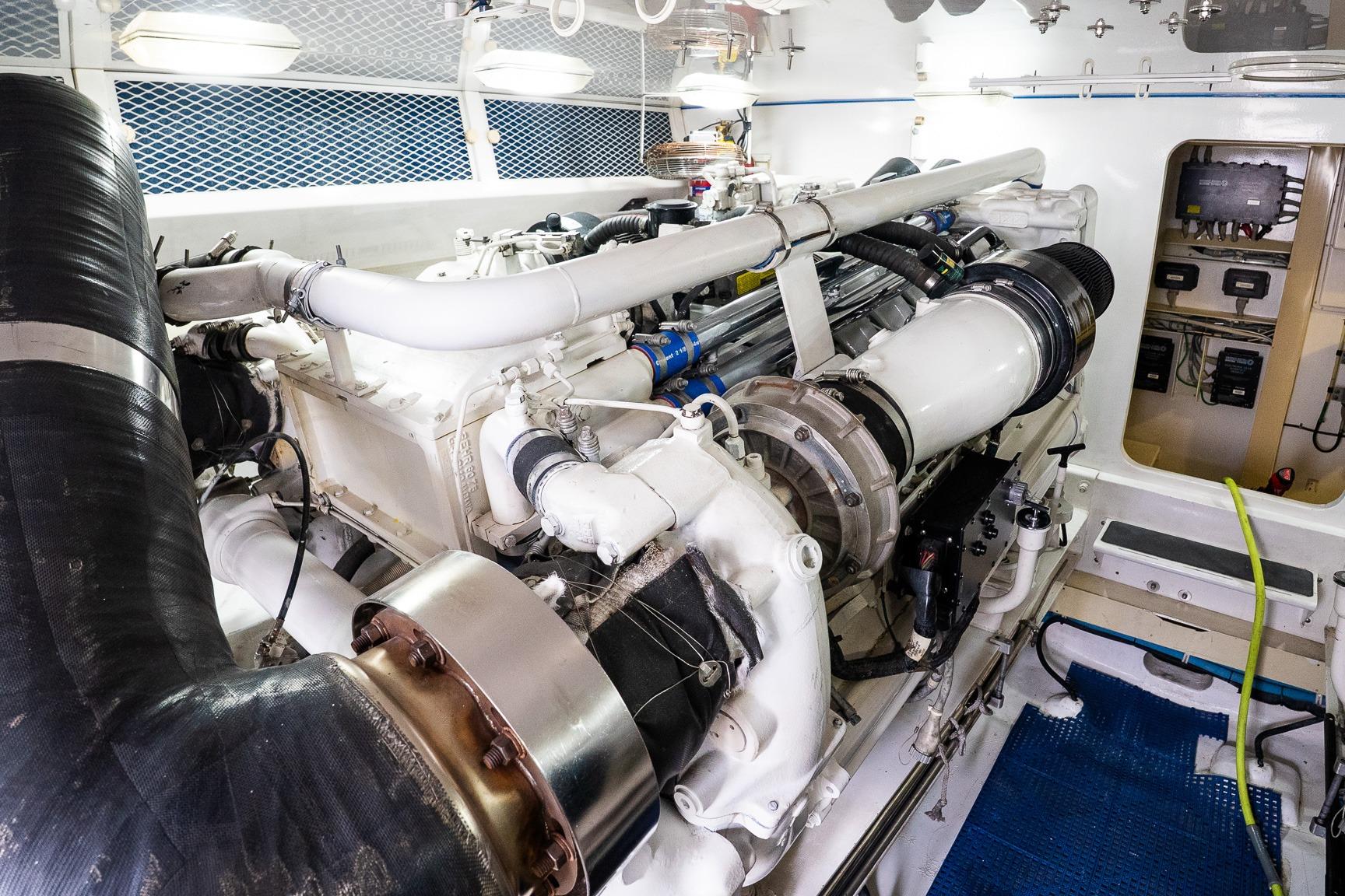 Engine room of a 2002 Viking 61 Enclosed Bridge yacht, showcasing machinery and components.