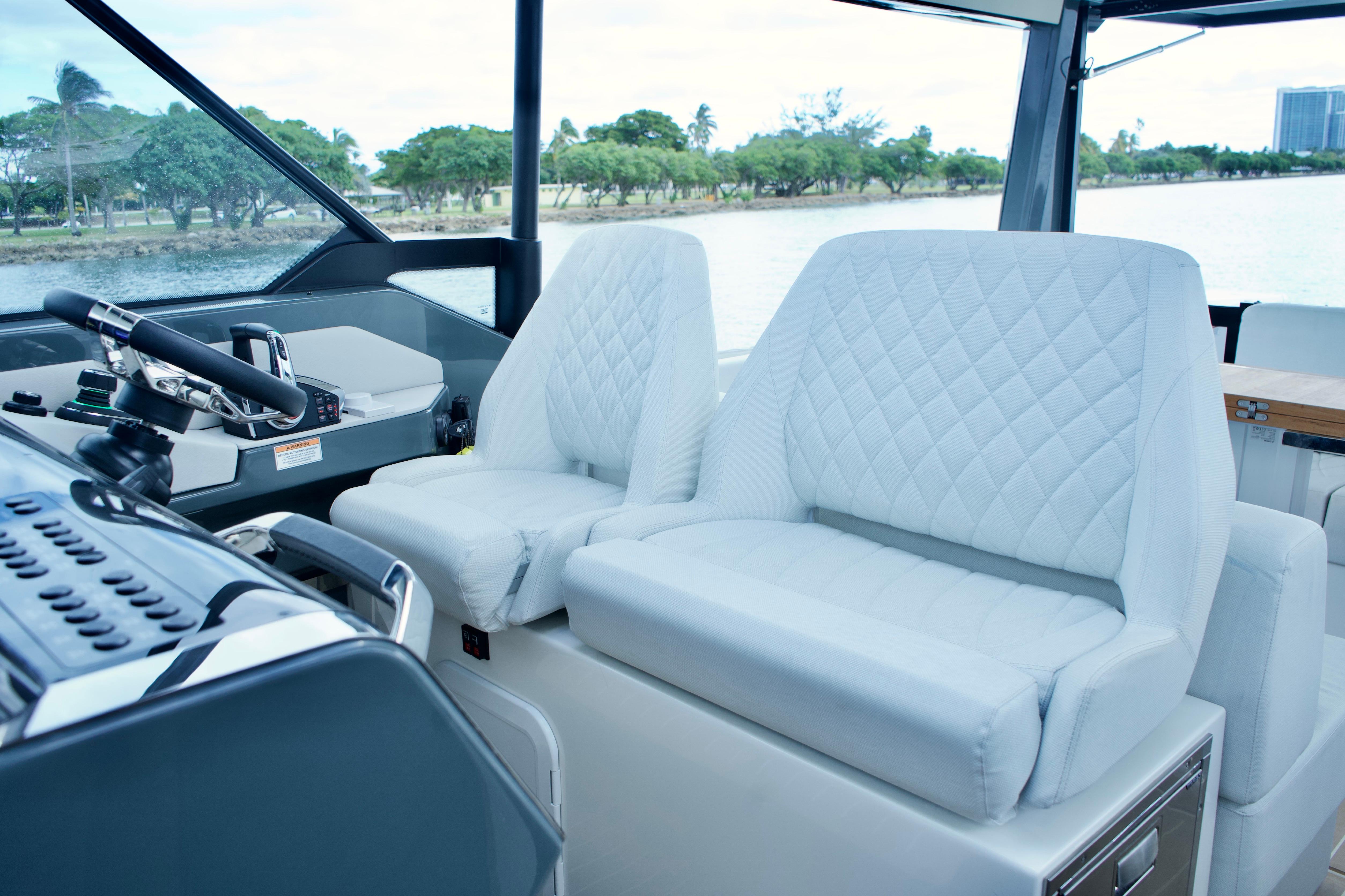 Luxurious interior of 2025 Saxdor 400 GTO boat with quilted white seats.