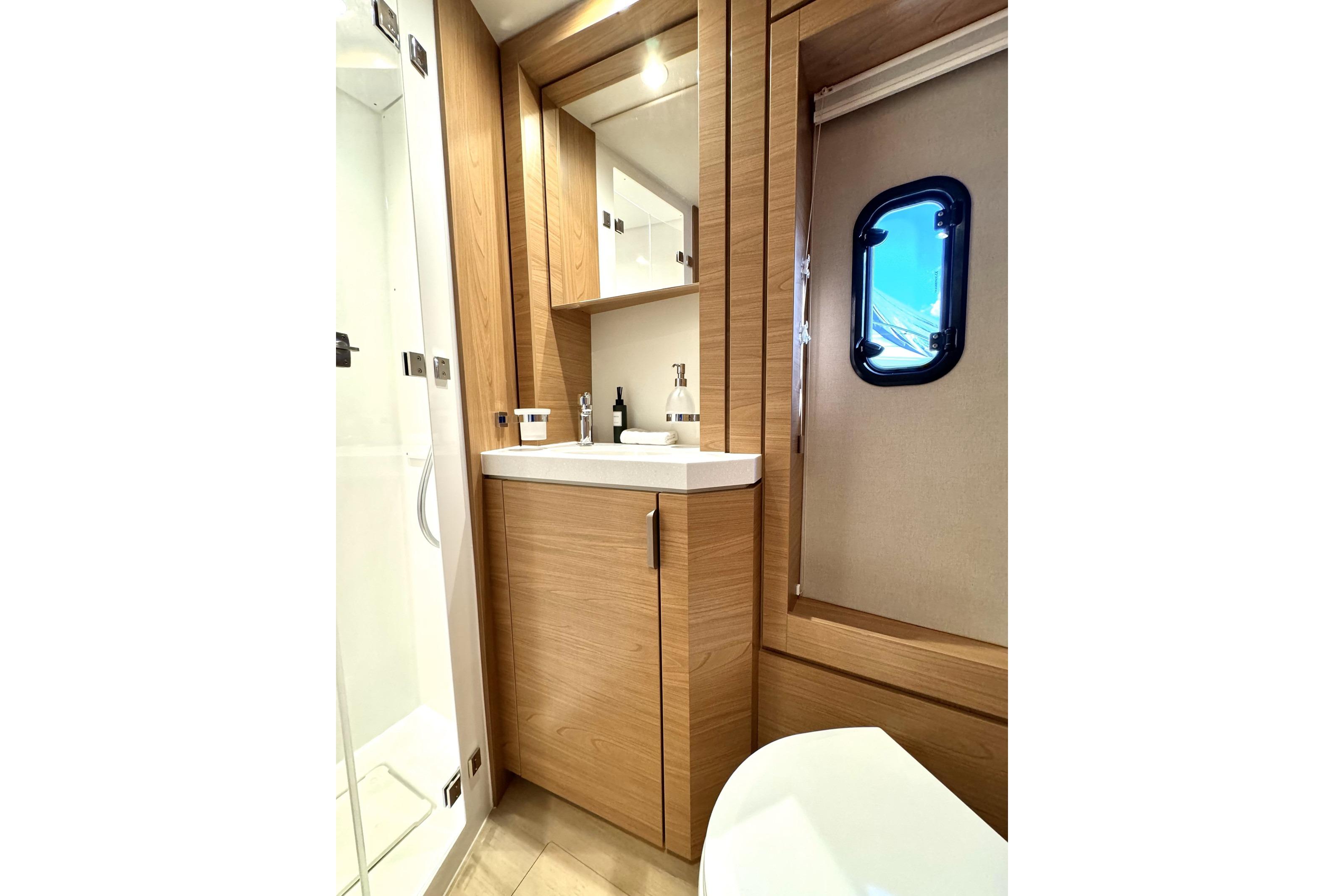 Modern bathroom in 2024 Bali 4.6 yacht with wood accents and sleek fixtures.
