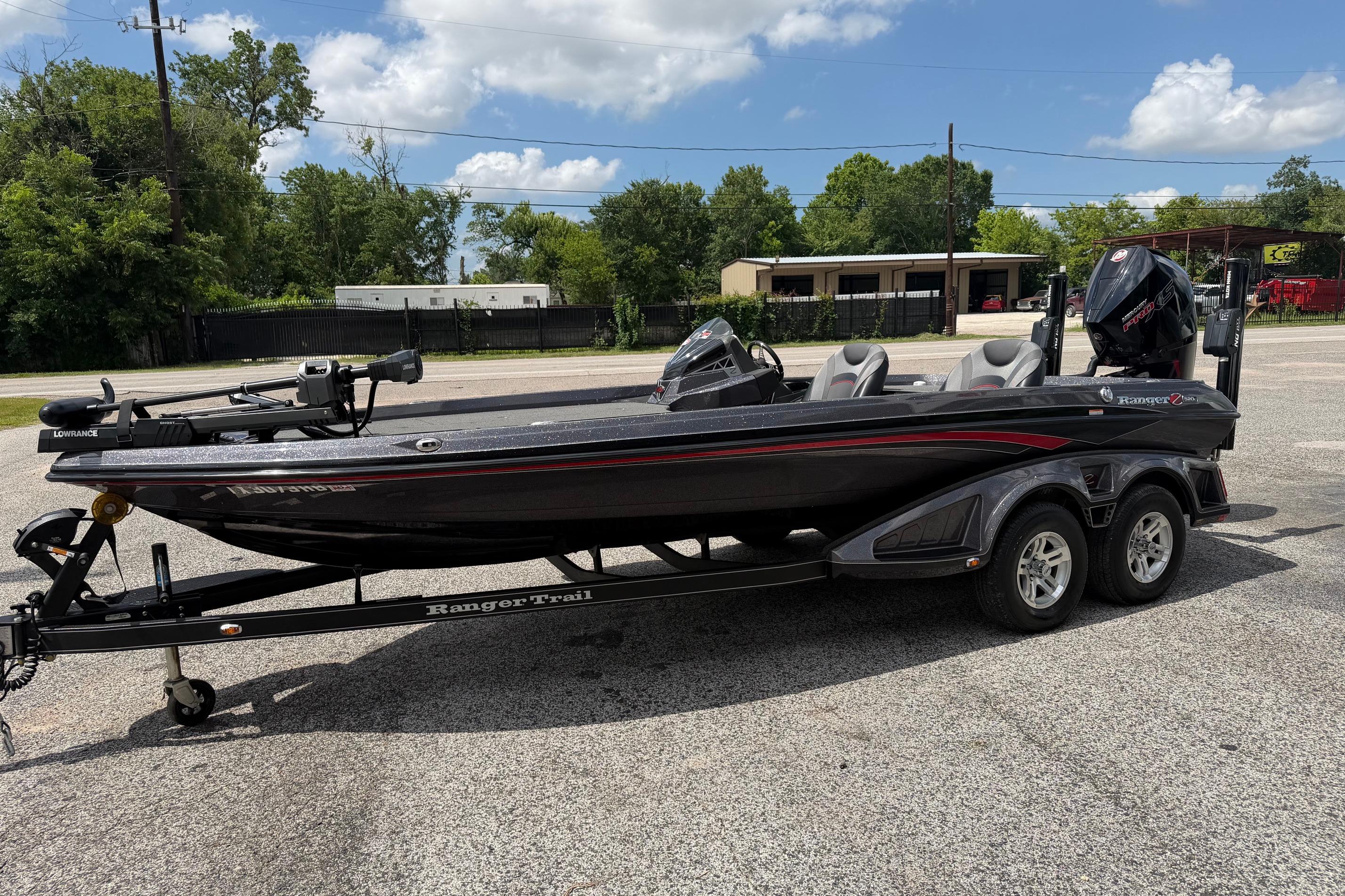 2020 Ranger Z520L bass boat on trailer, parked outdoors under a cloudy sky.