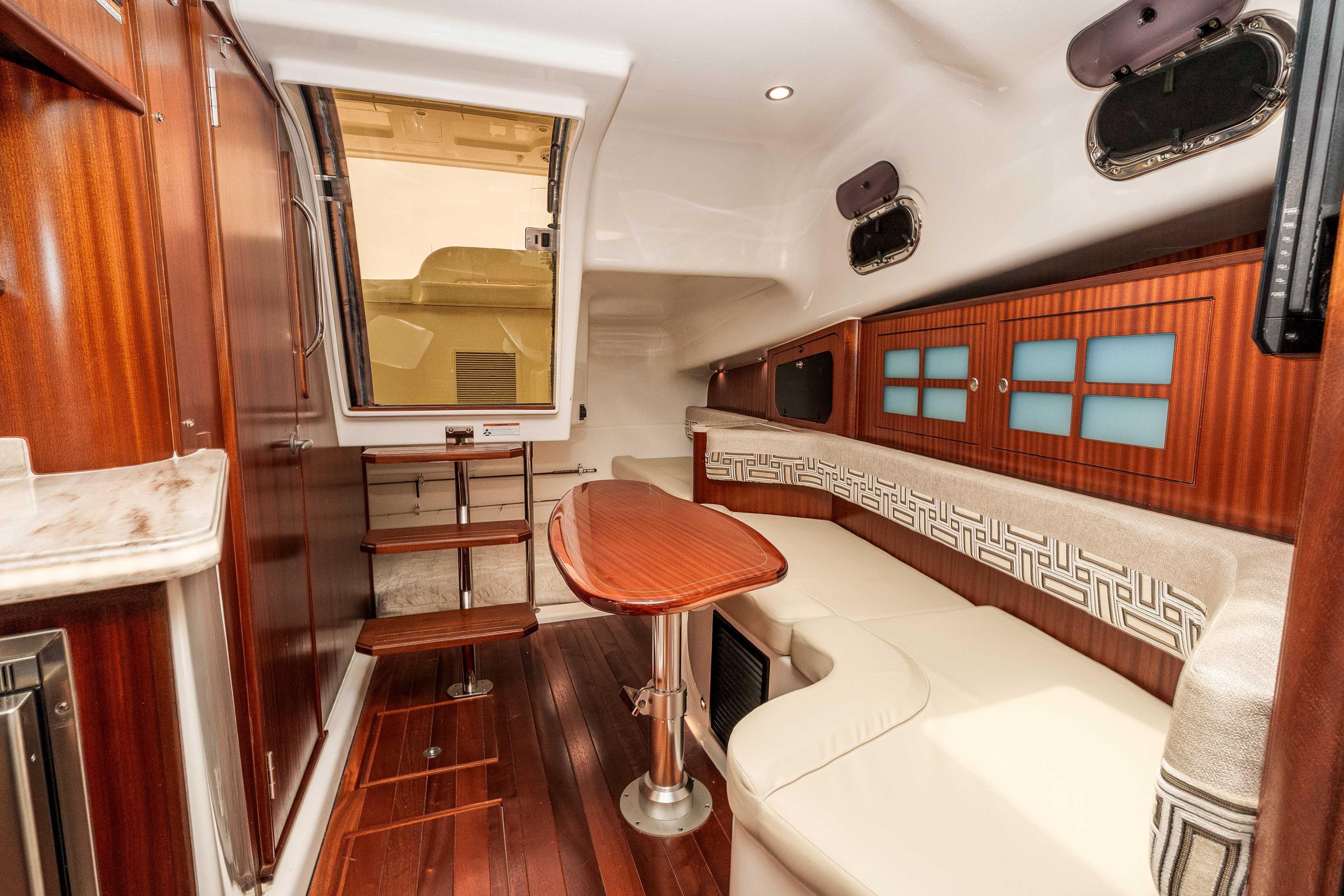 Luxurious interior of 2022 Pursuit OS 385 Offshore yacht with elegant wood finishes.