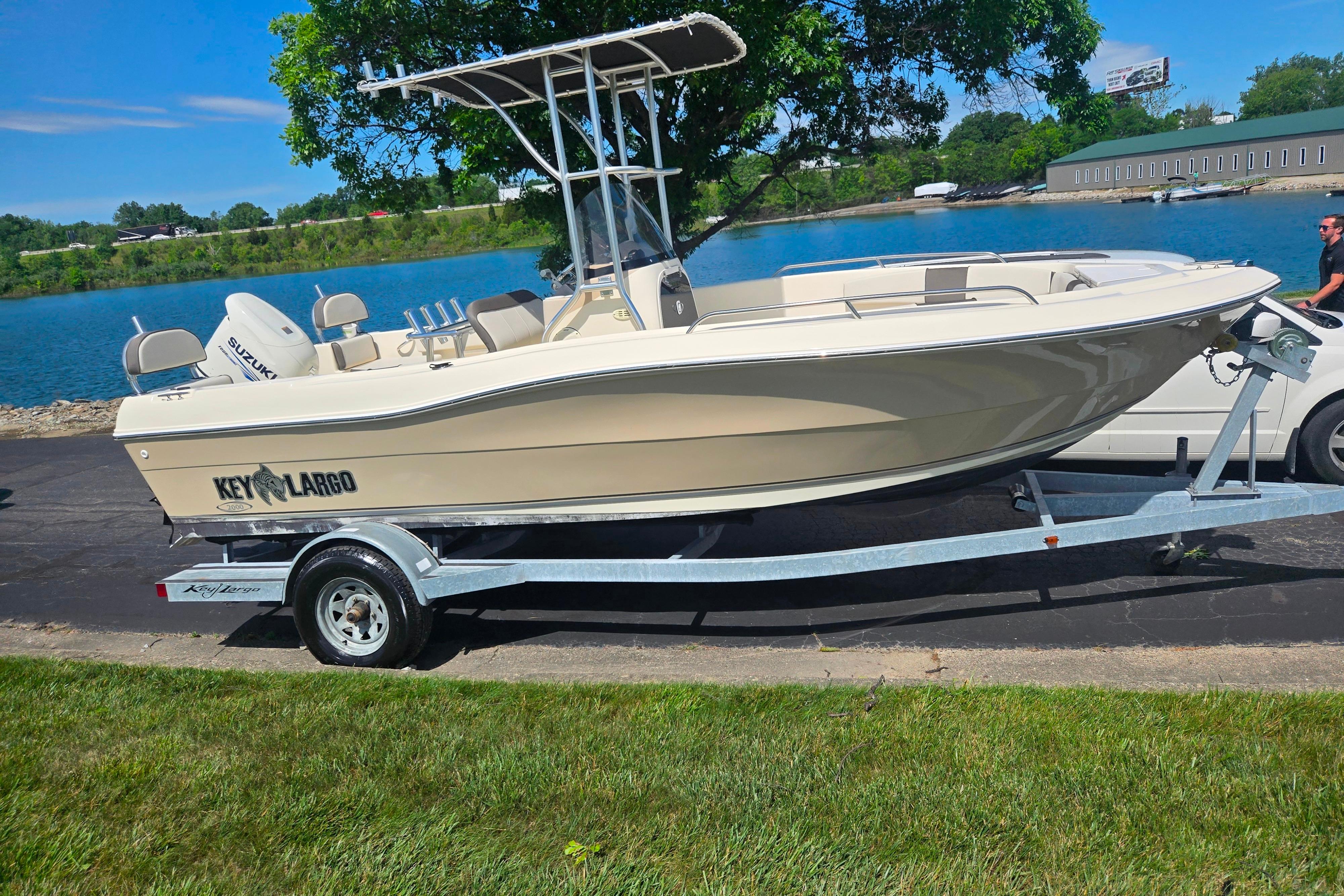 2016 Key Largo 2000CC boat on trailer by a lake, sunny day.