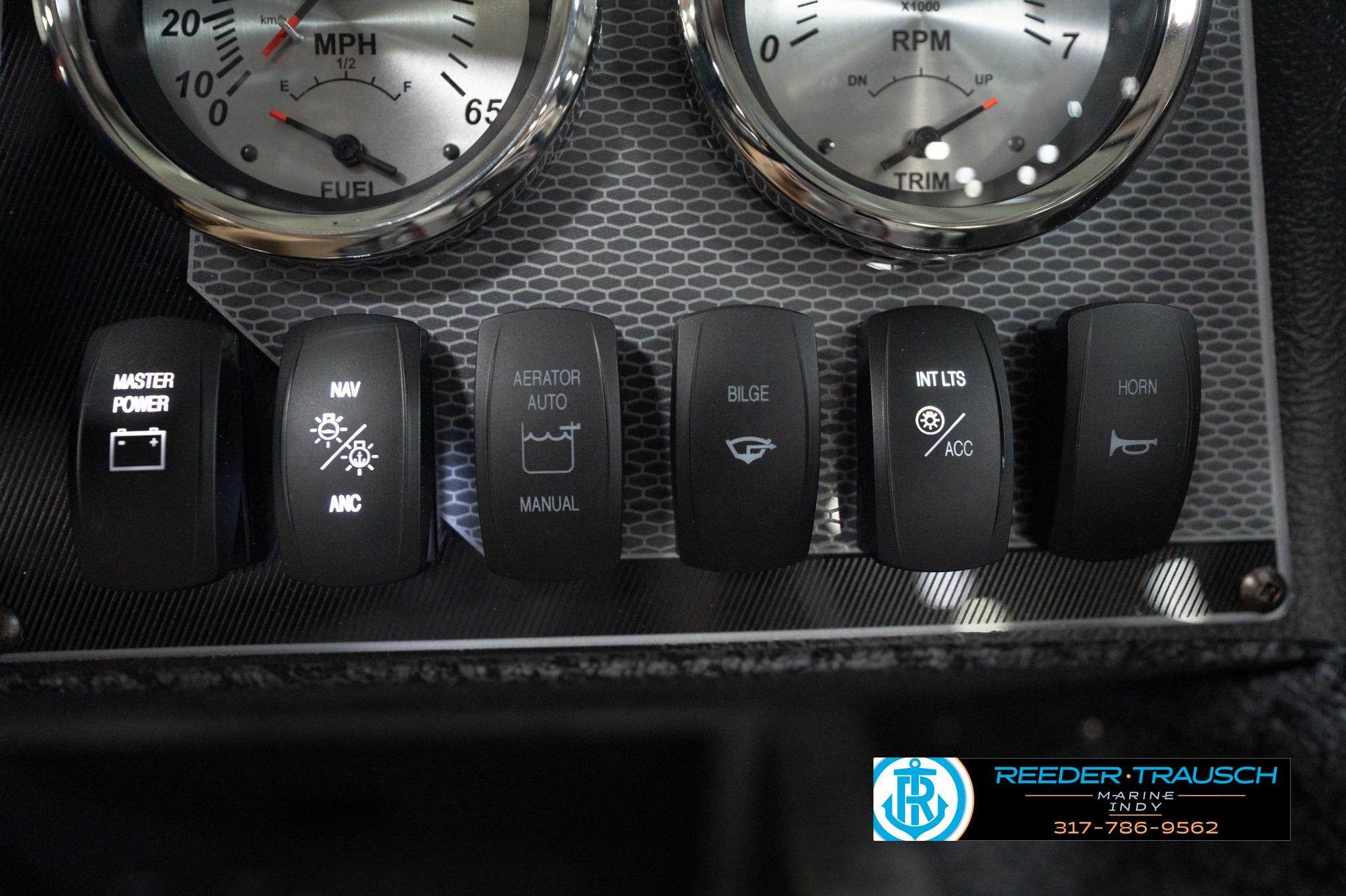 Dashboard controls of 2026 Lund 1800 Explorer Sport boat with gauges and switches.
