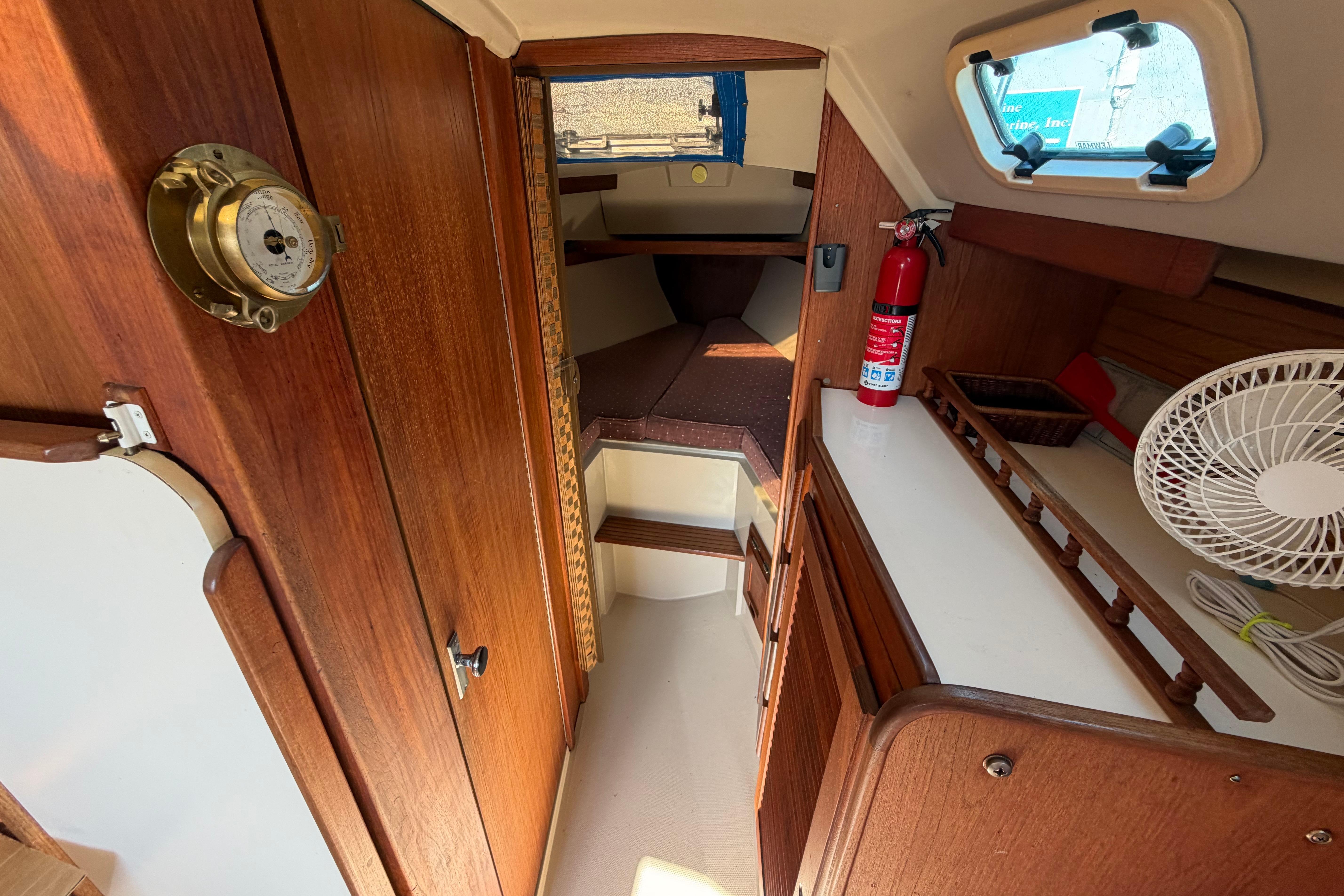 Interior of 1988 Catalina 30 MkII sailboat with wood paneling and nautical decor.