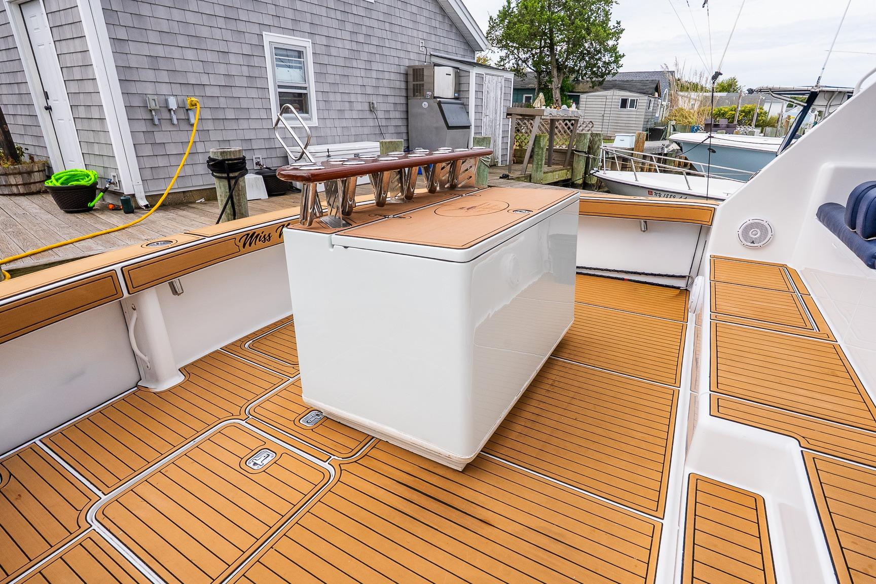 2002 Viking 61 Enclosed Bridge yacht deck with teak flooring and fishing station.