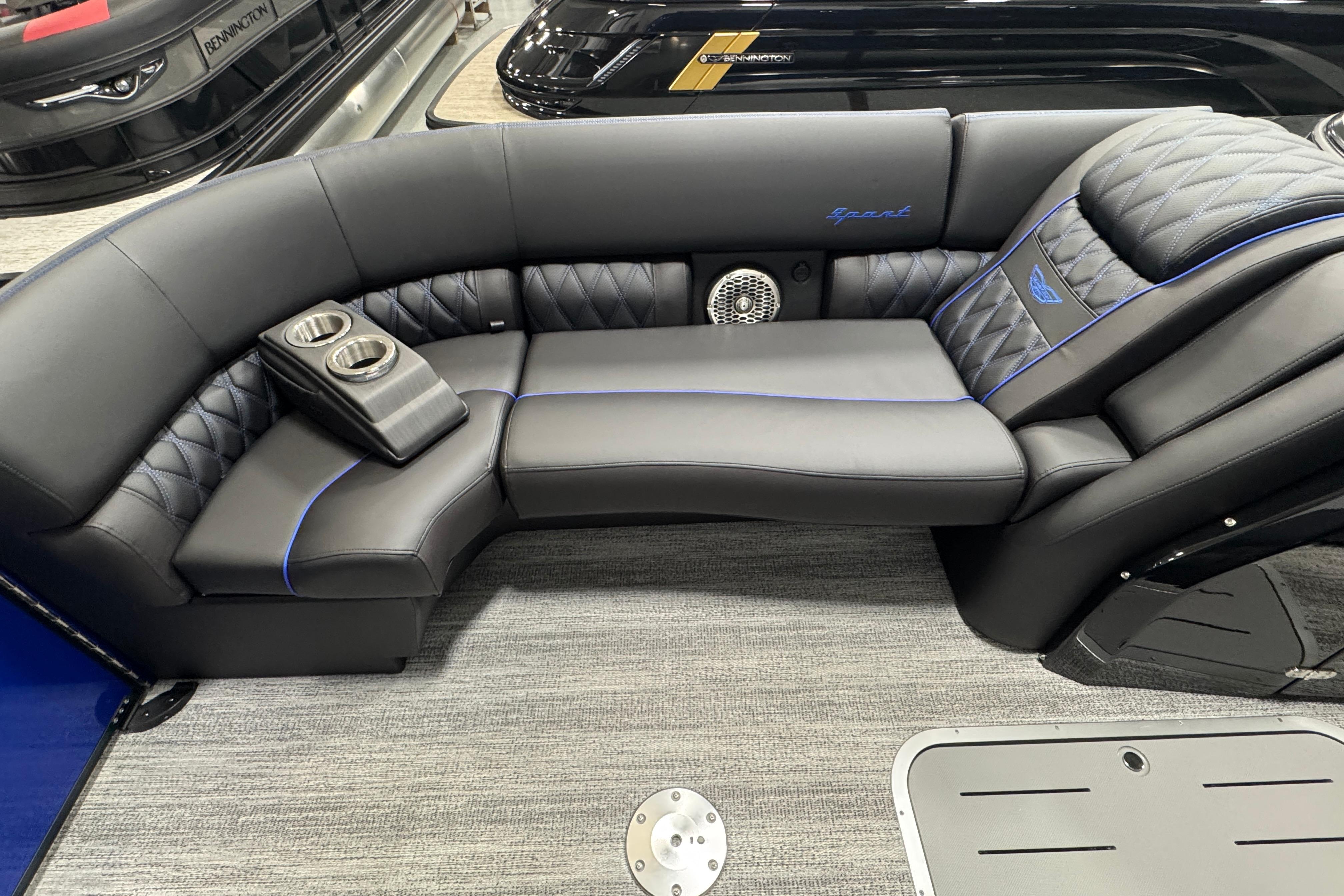 Luxurious seating on 2026 Bennington 25 QSBWASE boat with cup holders and elegant design.