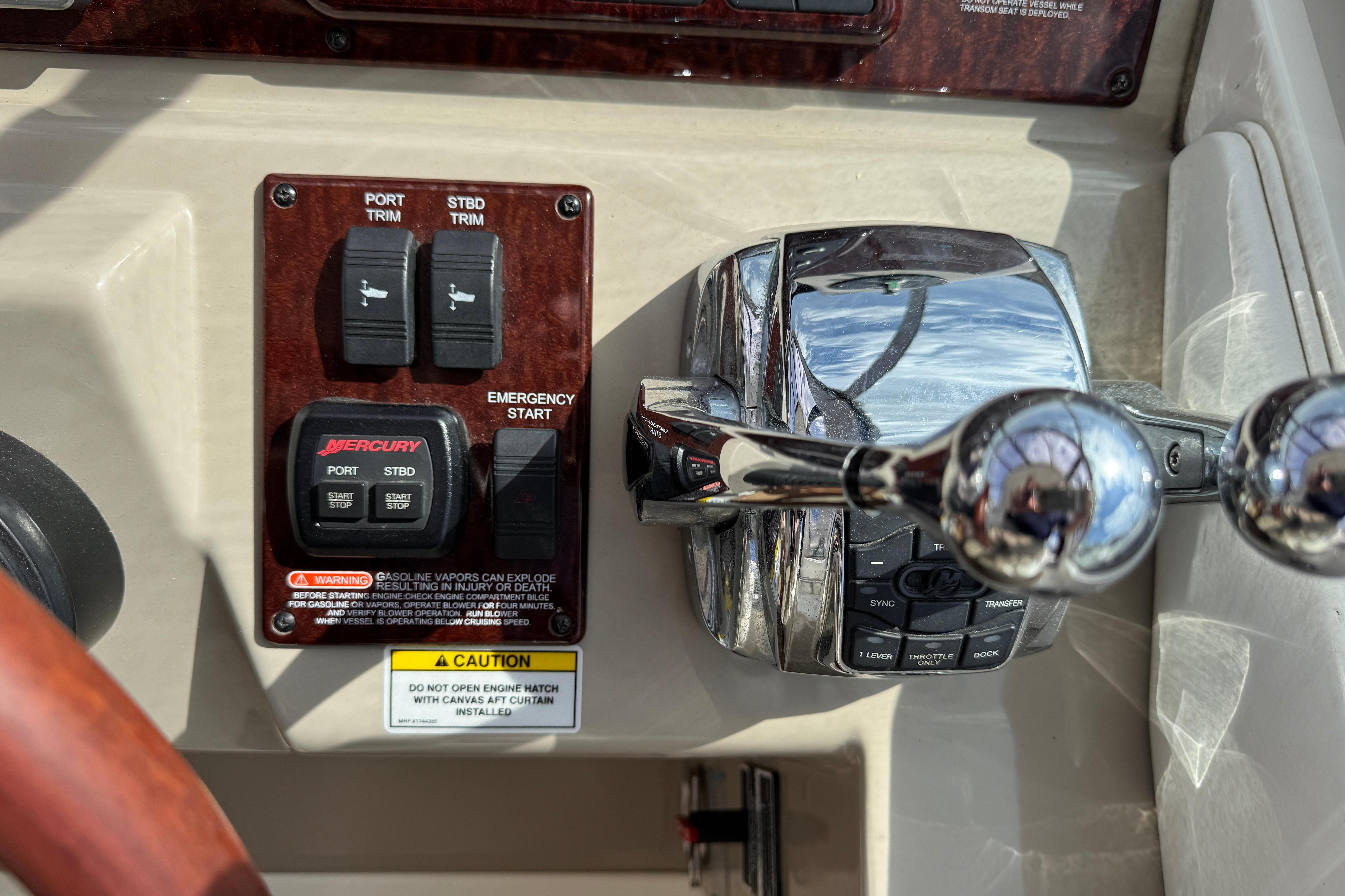 2008 Sea Ray Sundancer 350 helm controls with trim switches and throttle levers.
