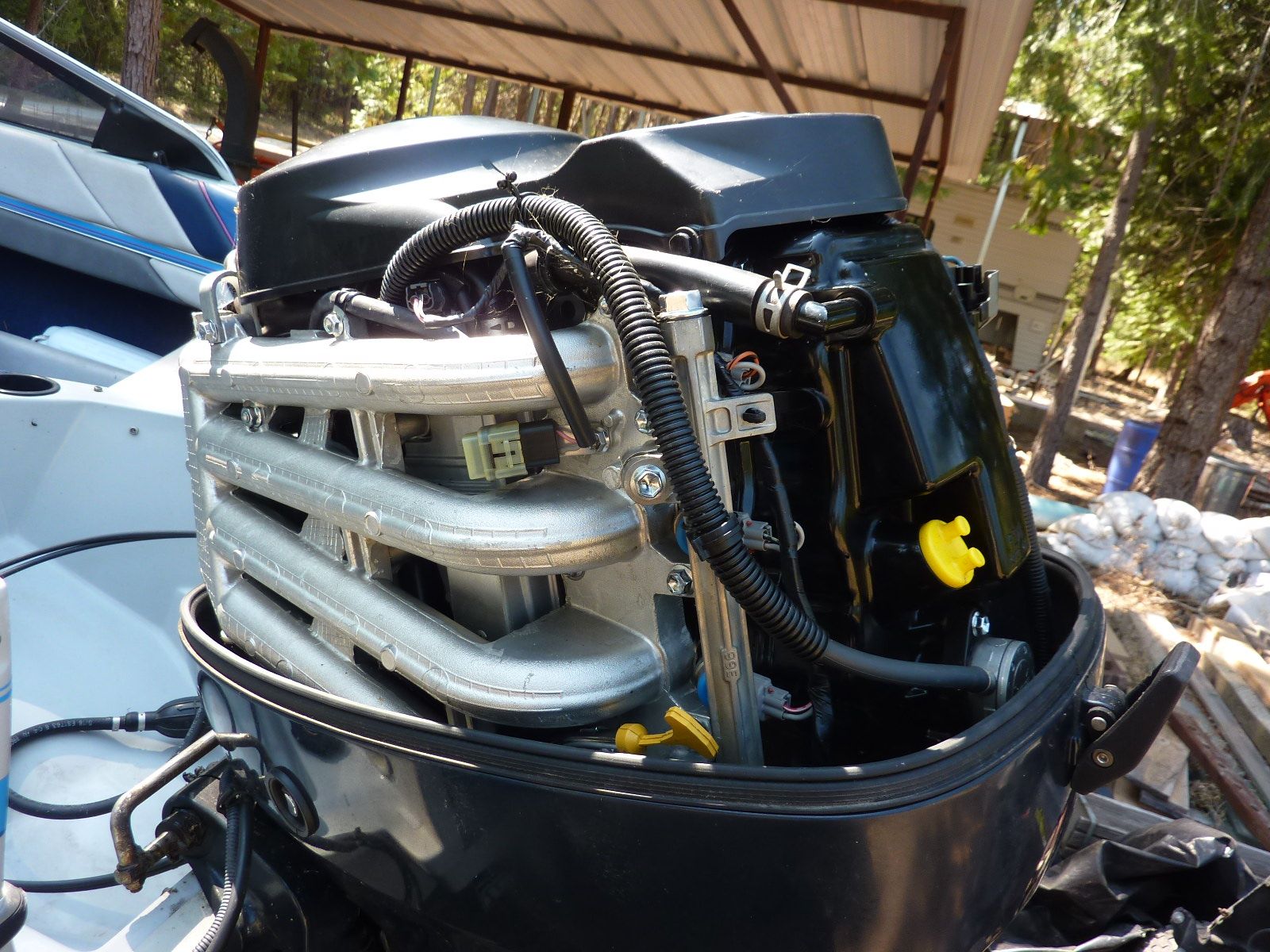 Close-up of a boat outboard motor under a covered area.