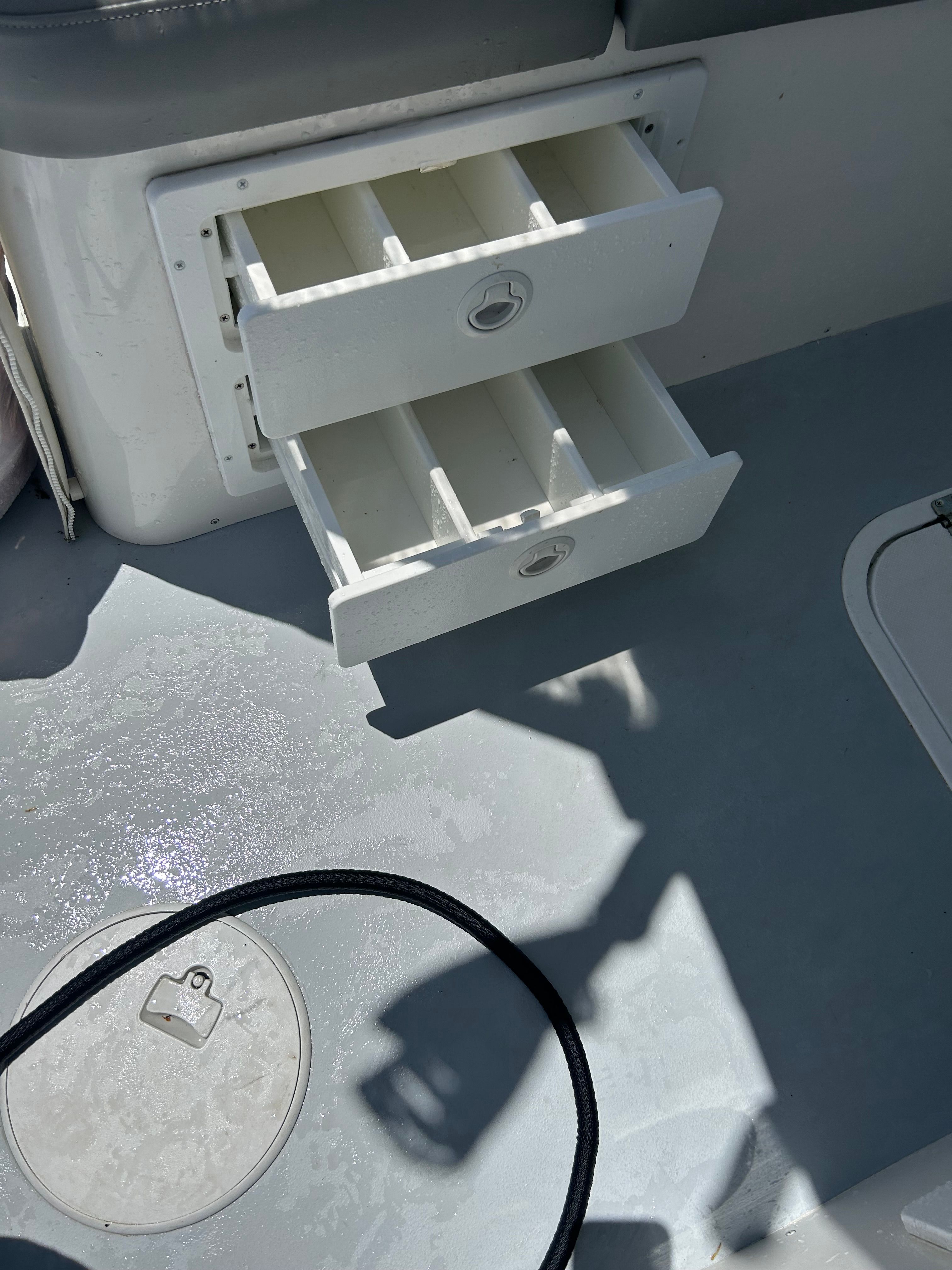 Open drawers in the cockpit of a 2019 Steiger Craft 28 Miami boat.