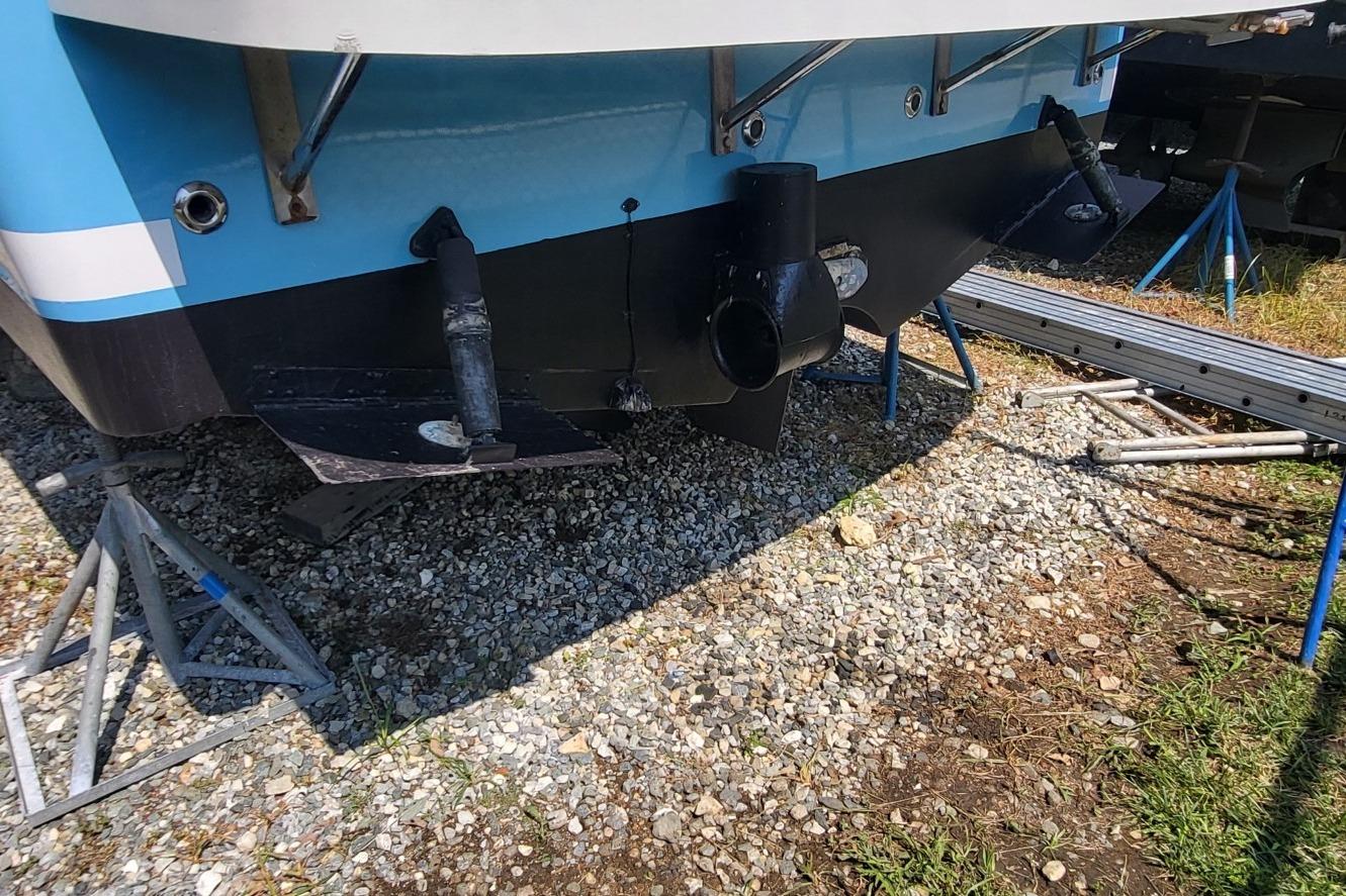 2006 Back Cove 29 boat hull on stands, showing propeller and rudder.